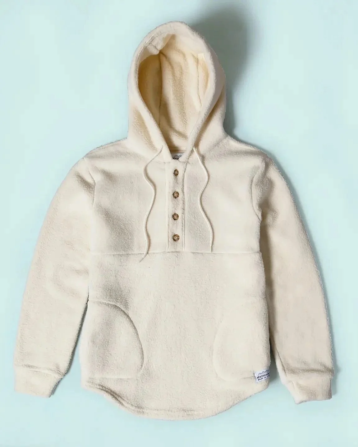 Cream-colored fleece hoodie with a front button placket, drawstring hood, and a small label on the bottom right.