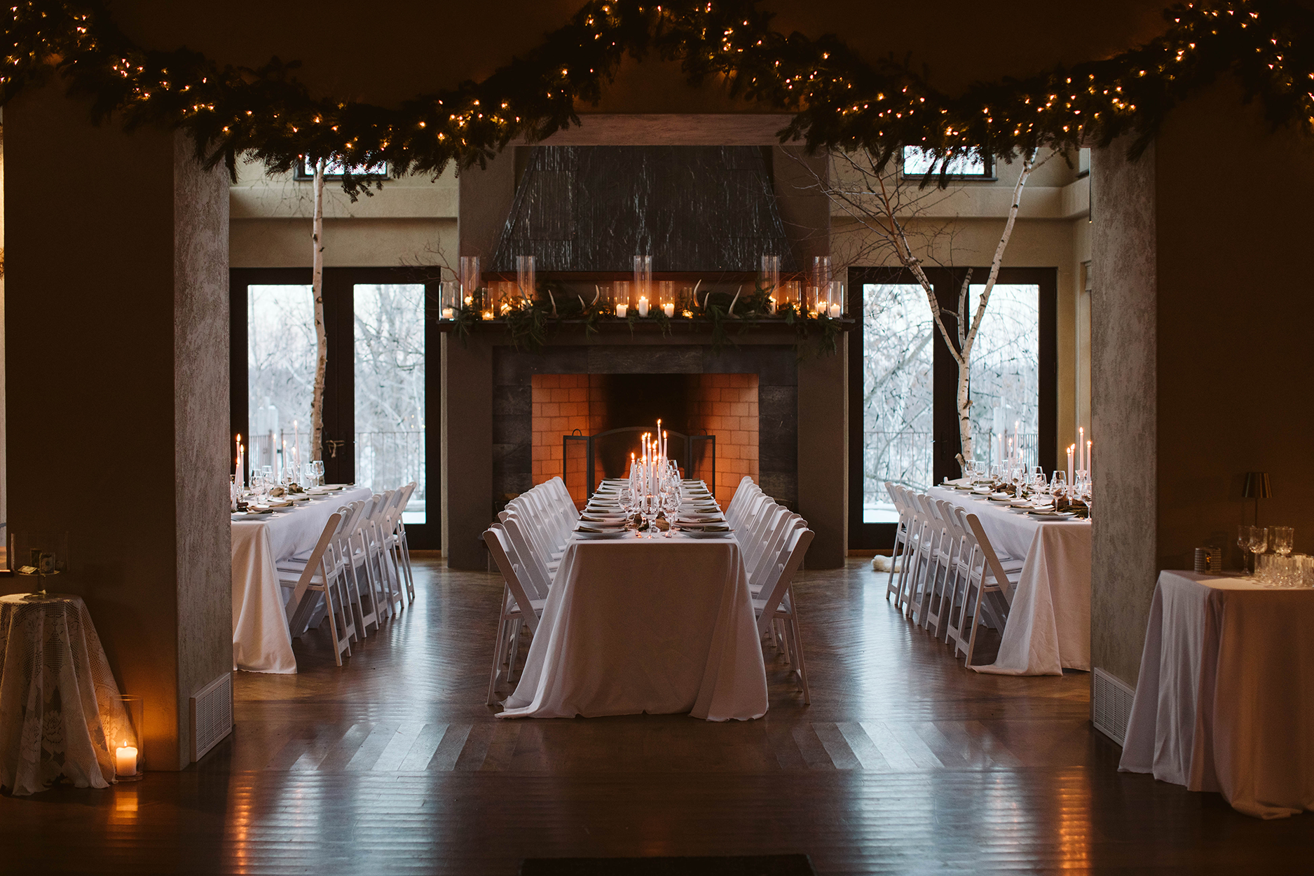 Holiday Dinner Set Up in Front of a Fireplace with candles.