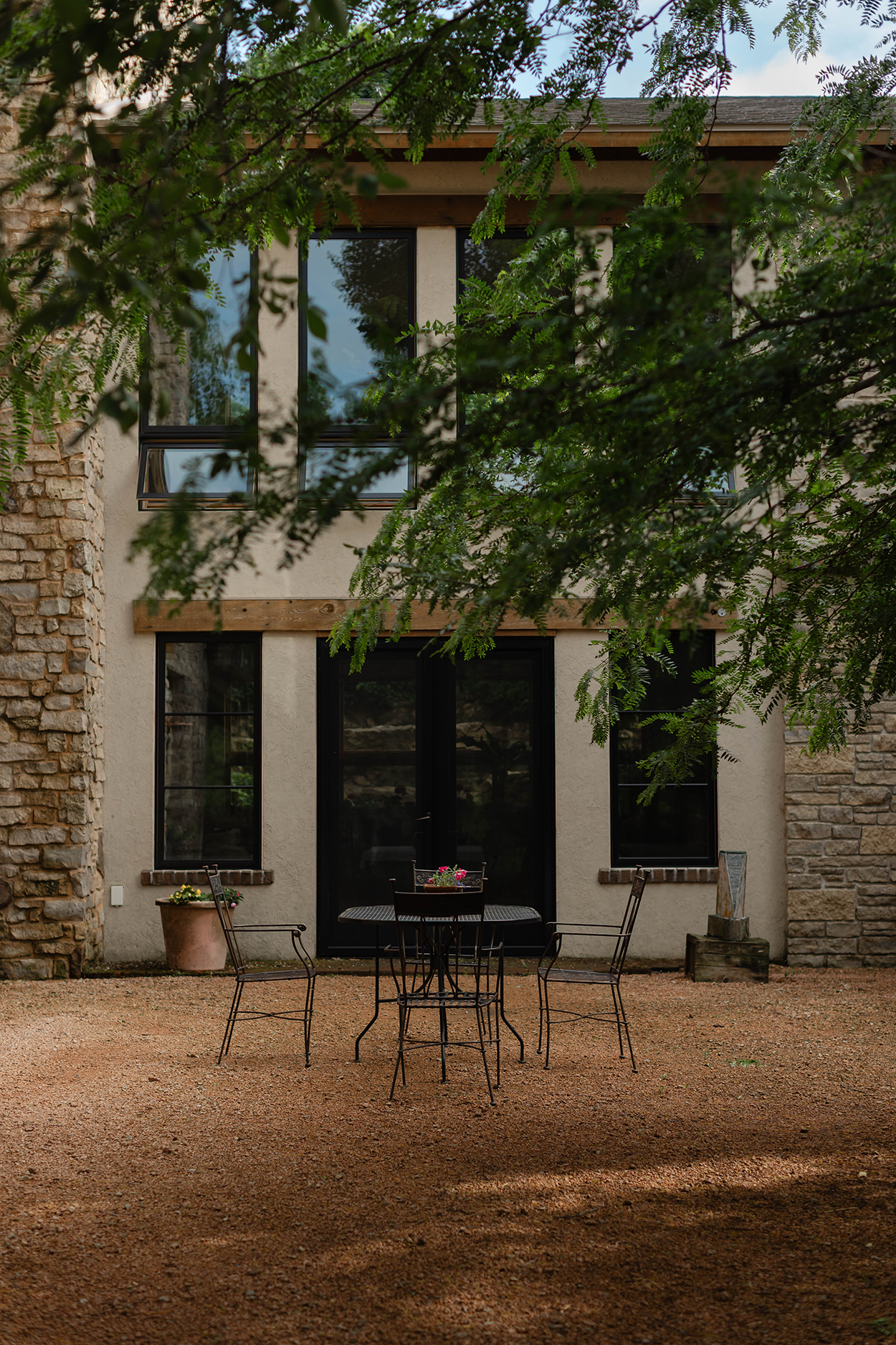 Crushed red granite courtyard with a tree above it.