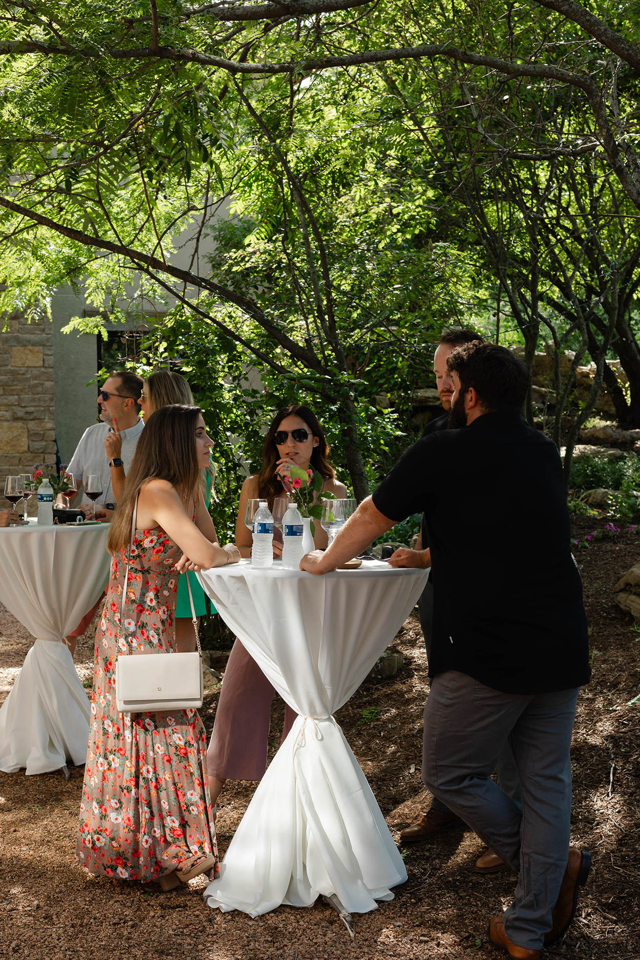 A group of people chatting in an Italian courtyard.