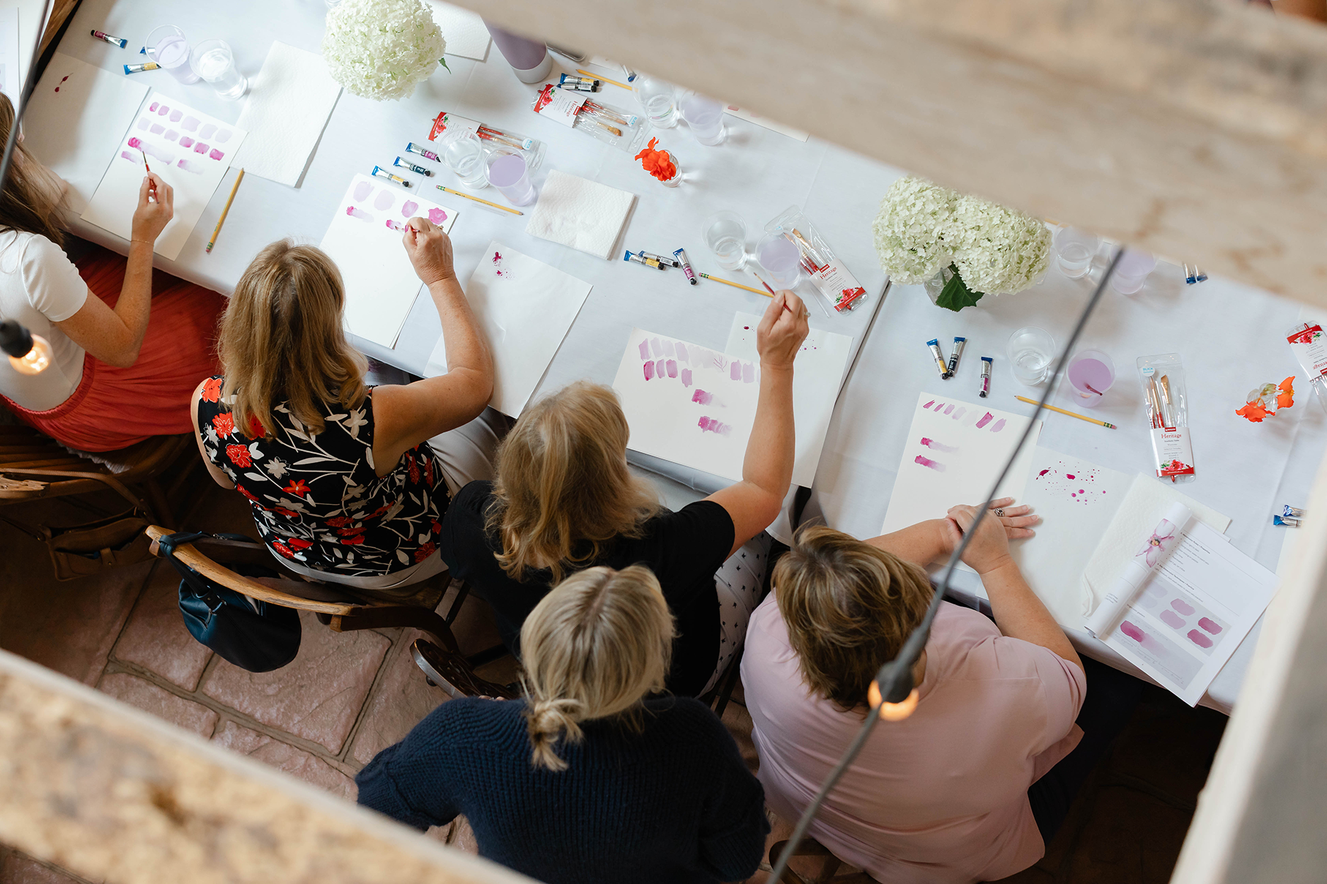Women watercoloring in a garden room.