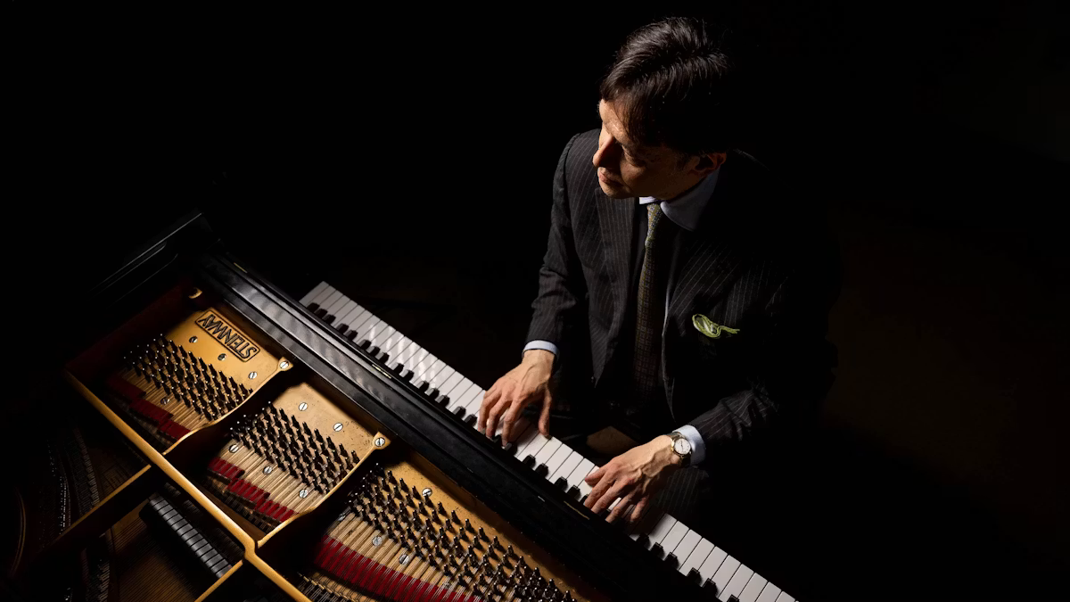 Photo from above of a young man playing the piano