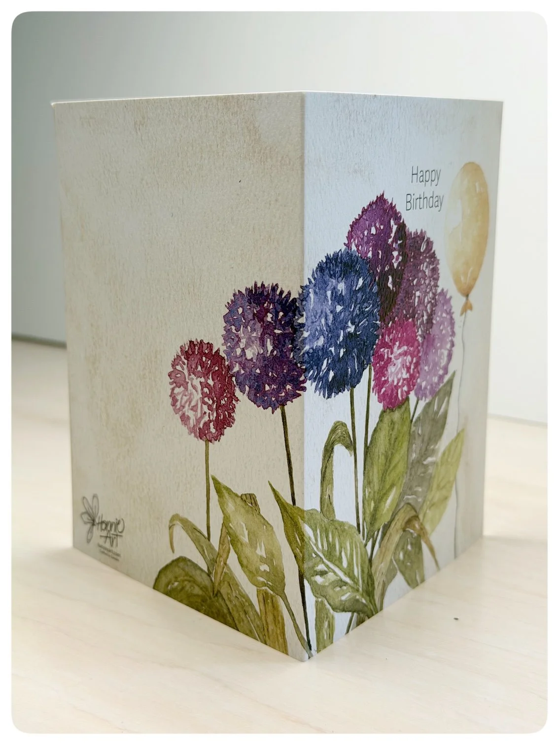 Side view of floral birthday greeting card showing wrap around watercolour allium artwork