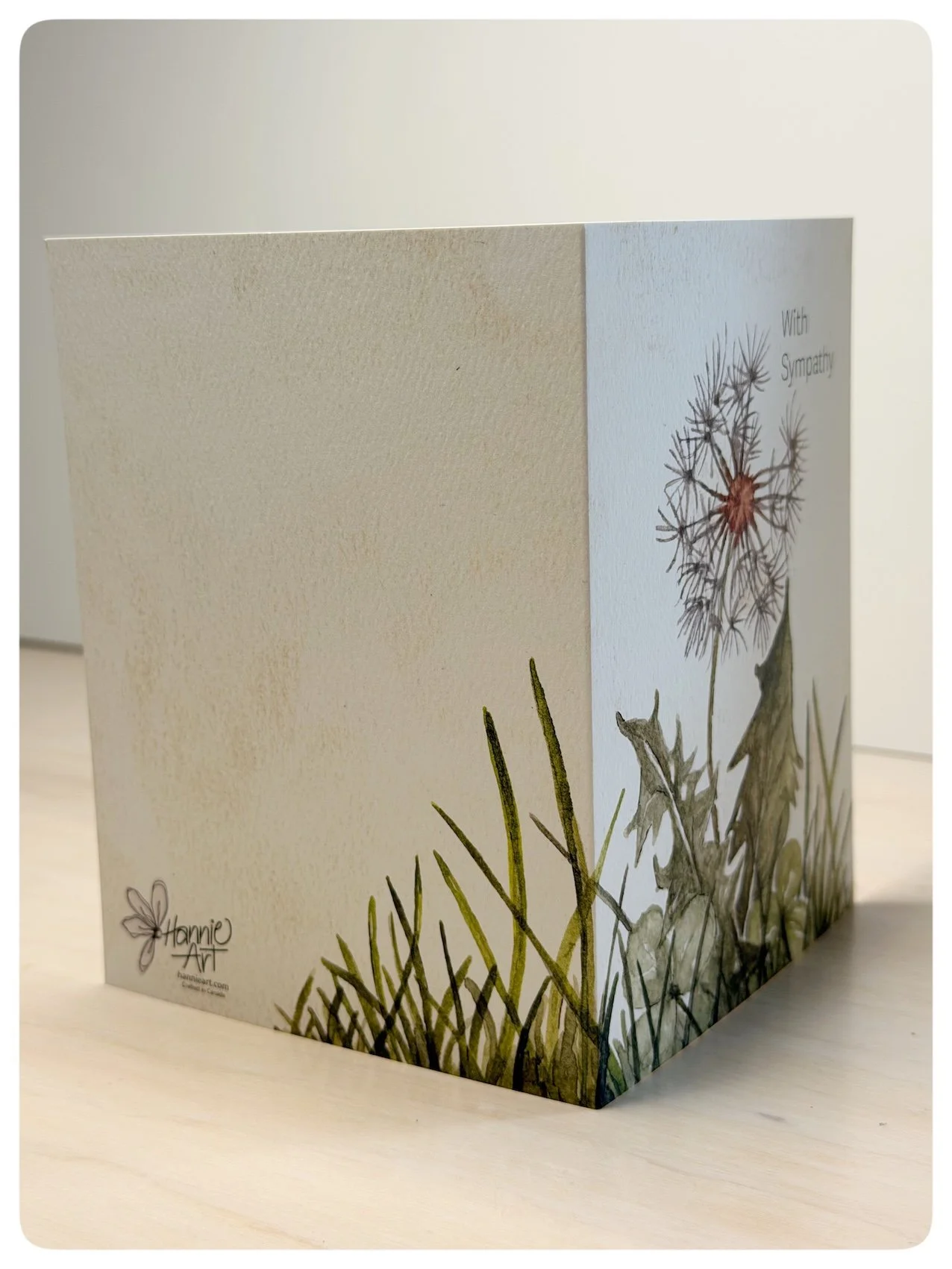 Side view of dandelion sympathy greeting card showing wrap around watercolour grasses