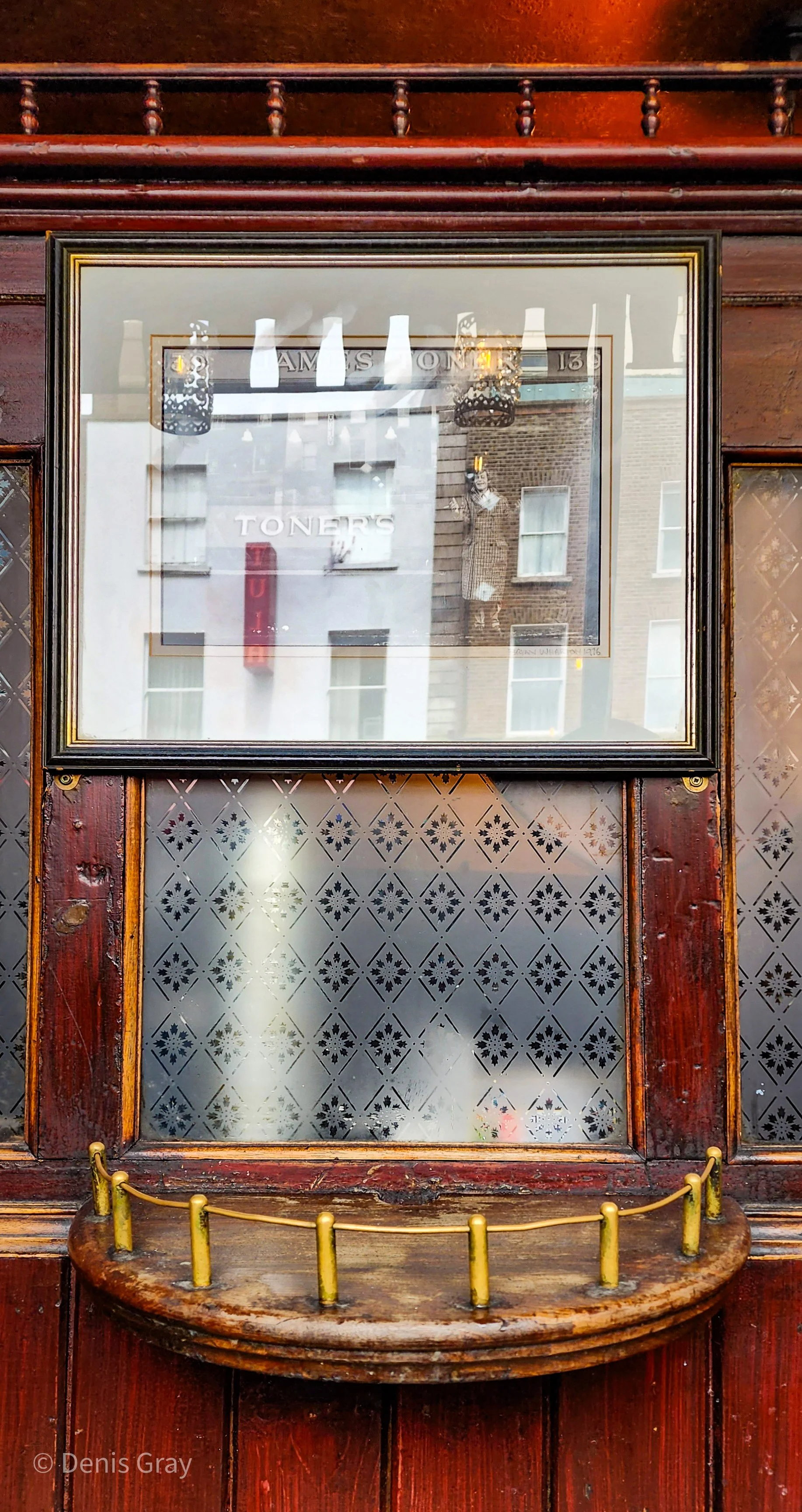 Toner's, Baggot St., Dublin. Framed Peter O'Toole image (1976), reflecting the buildings across the street.