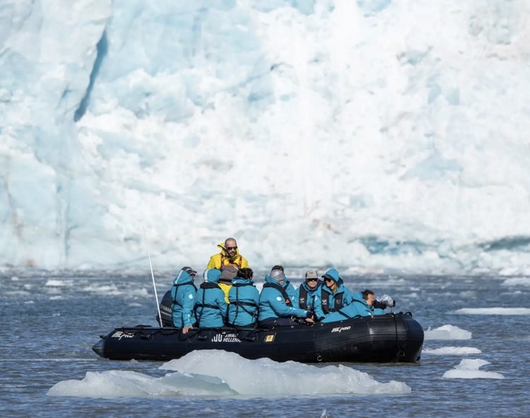 Zodiac with guests exploring the coastline