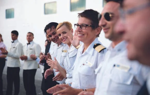 Regent crew greeting guests