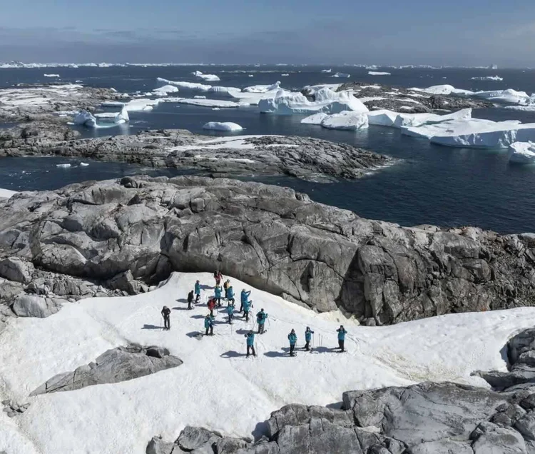 Guests hiking ashore in a polar landscape