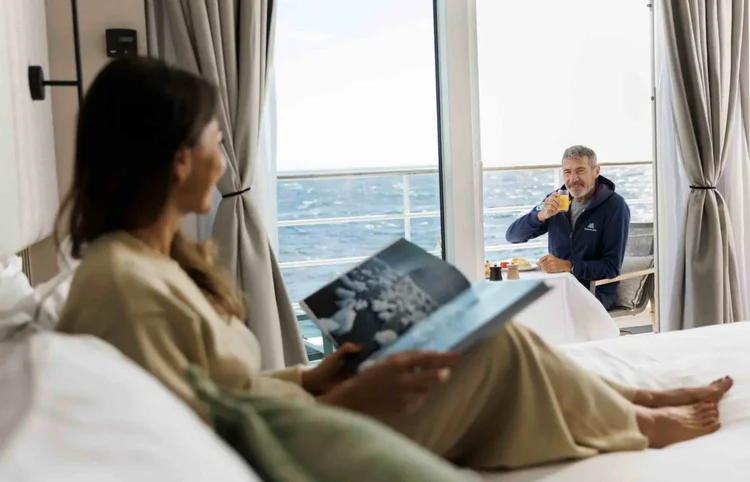 Guests relaxing on the balcony and bed, Swan Hellenic