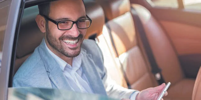 Guest relaxing in a private car transfer