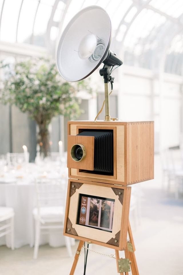 vintage style photo booth rental with camera and flash setup at indoor event