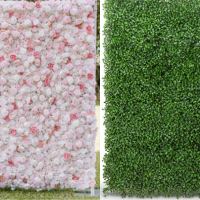 Two vertical sections of artificial grass and flower wall decor, with pink flowers on the left and green grass on the right.