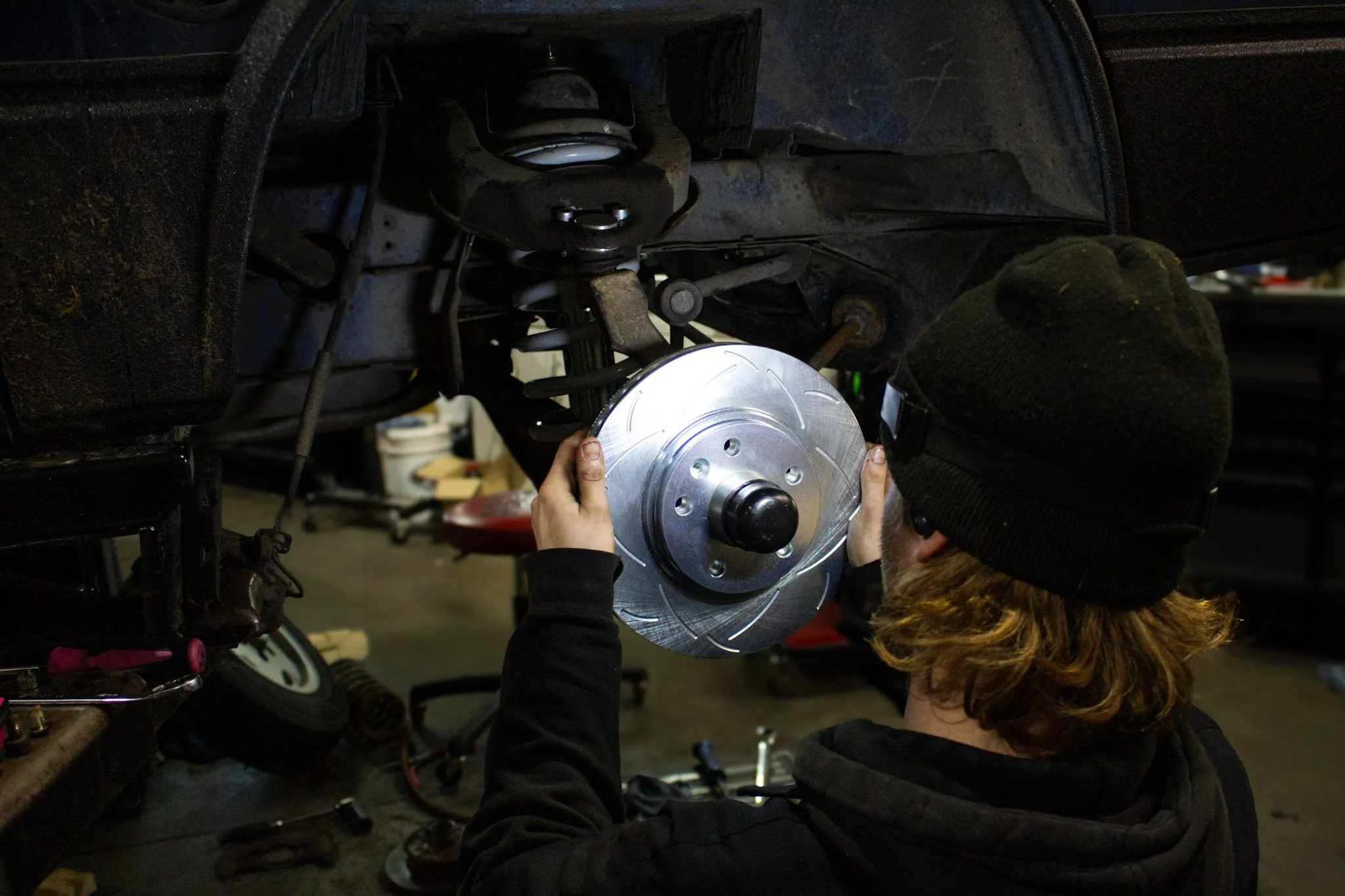 Professional German auto technician working on a BMW