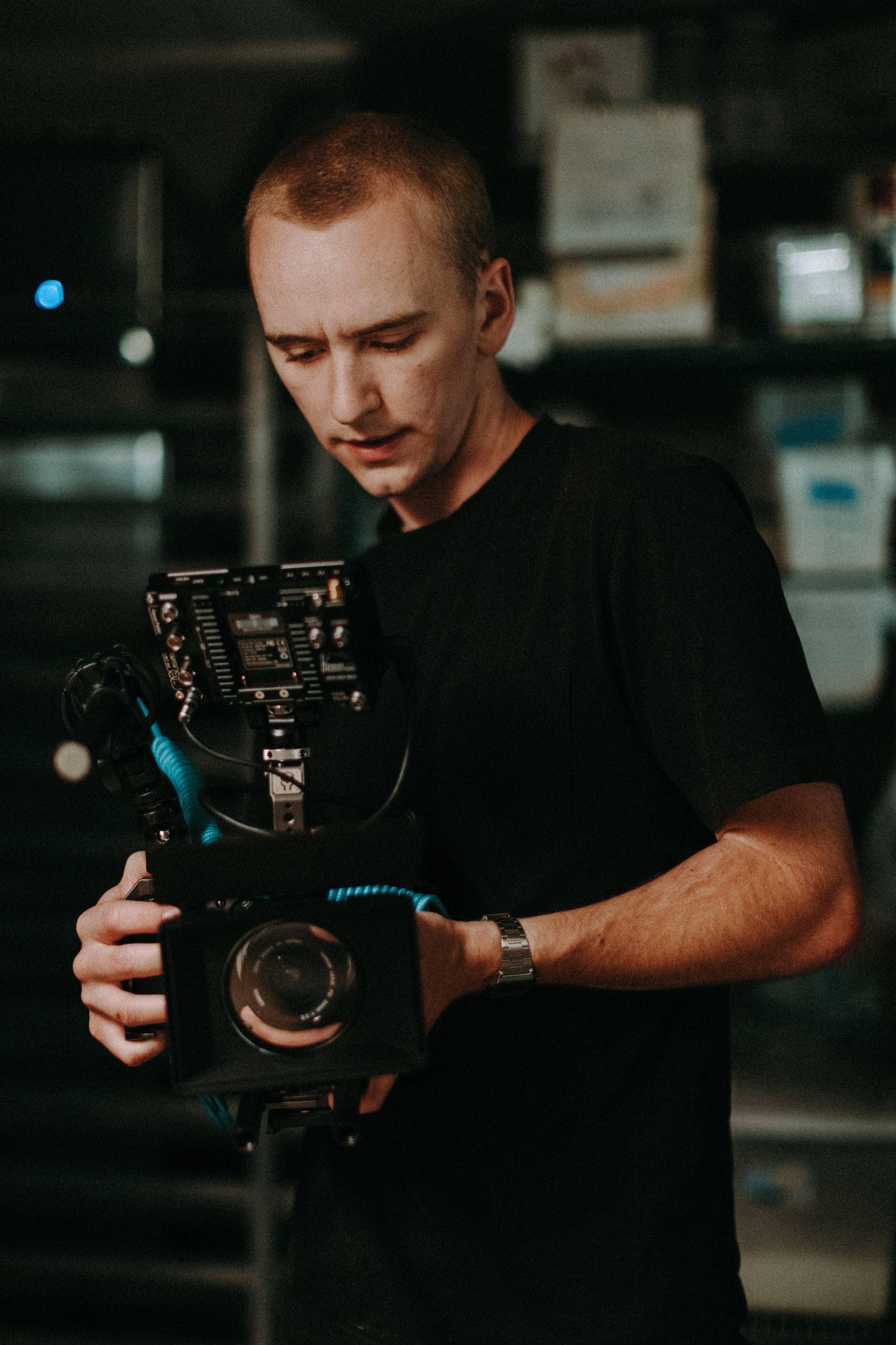 Person holding a professional camera setup indoors.