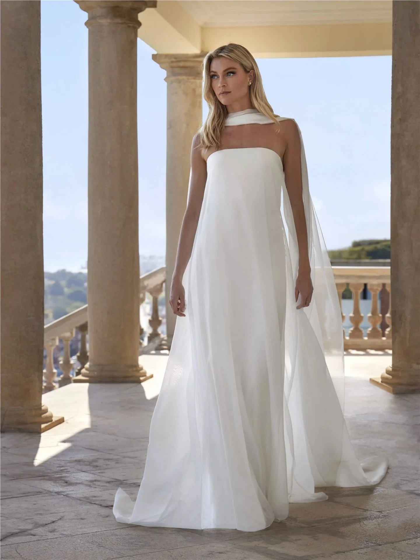 Introducing Xantal by Pronovias ✨

A sleek, straight silhouette with a strapless neckline, finished with a flowing detachable stole for added movement and versatility. Crafted in organza and satin for a clean, modern and refined look.

Part of the ne