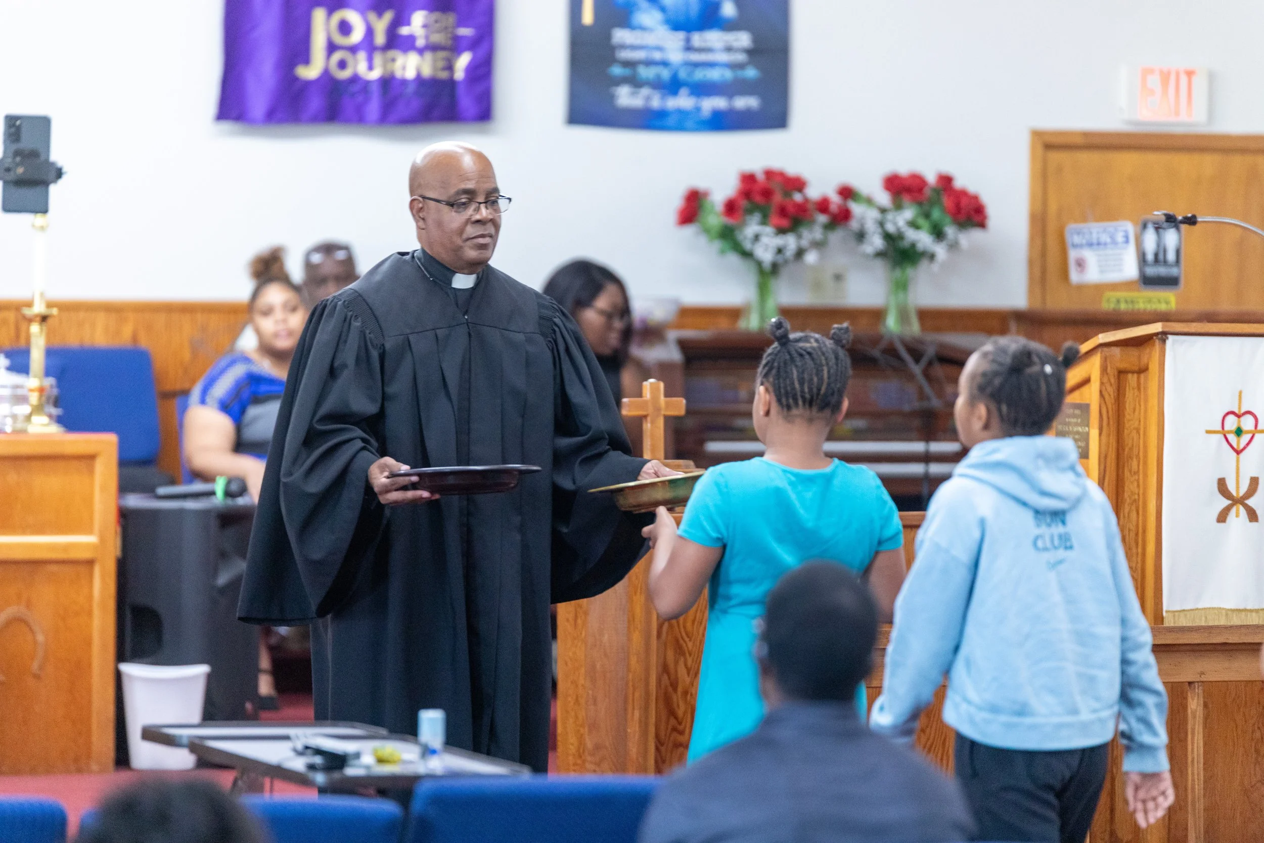 pastor leading Sunday worship at Visionary Hollowell Community United Methodist Church in Midland, Texas