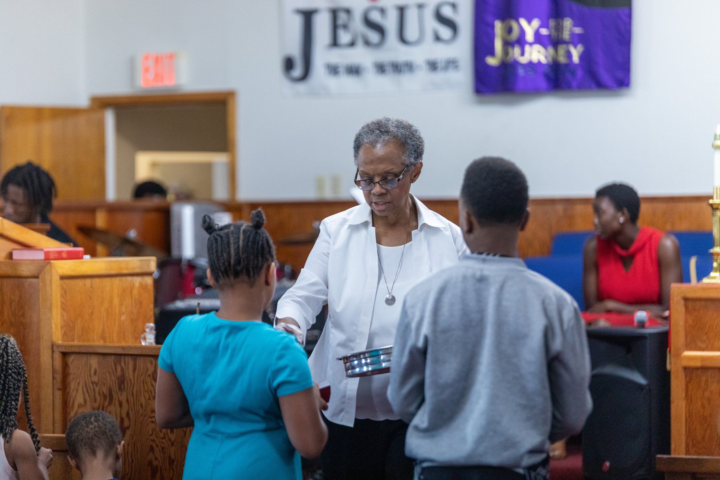 Church member serving communion at Visionary Hollowell Community United Methodist Church in Midland, Texas