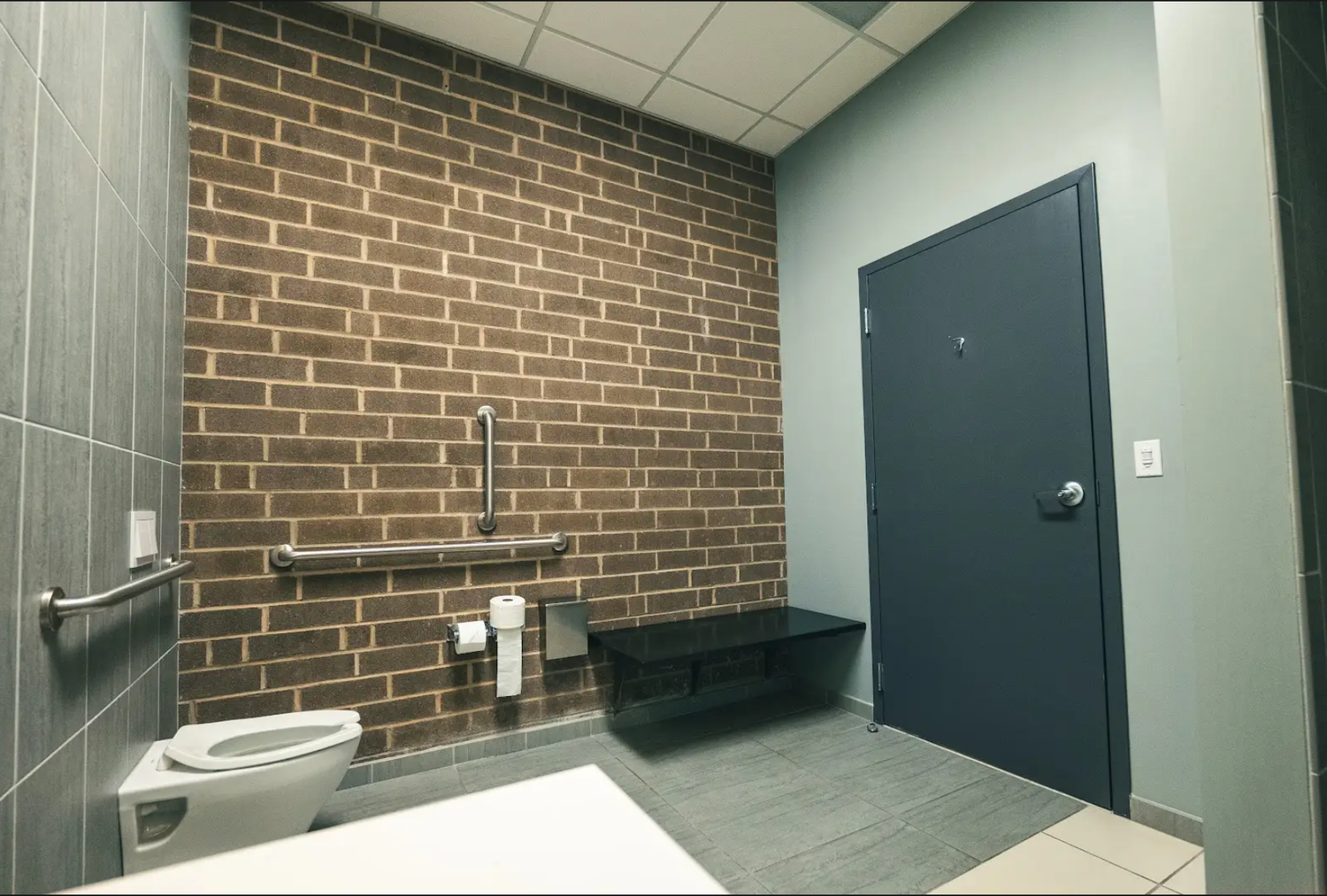 Private restroom with brick accent