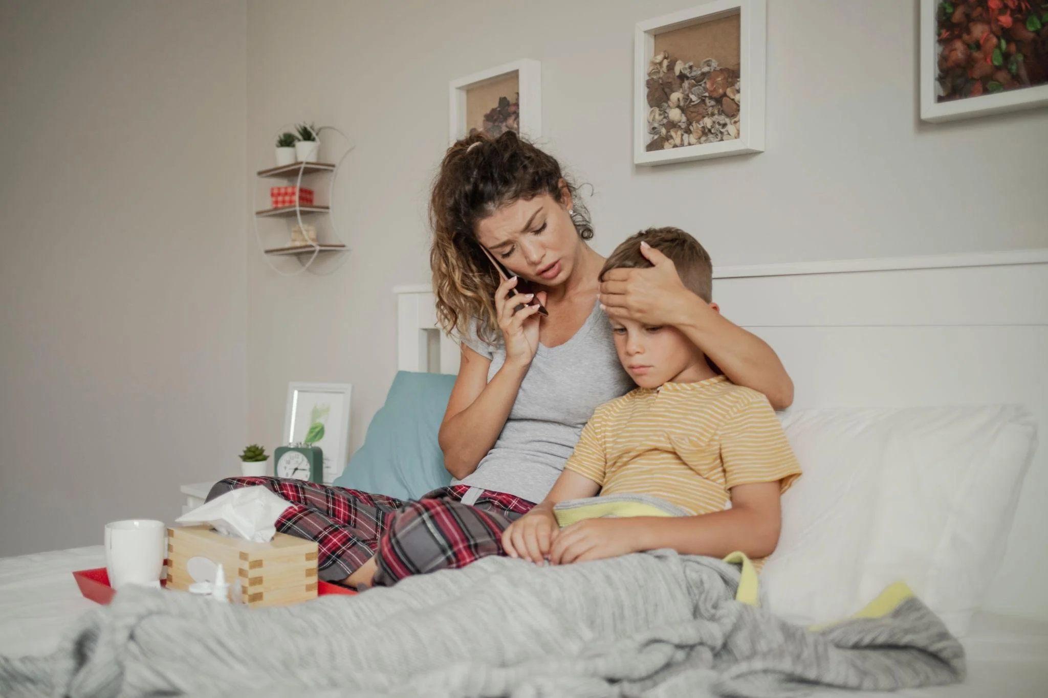 feverish kid with his worried mom