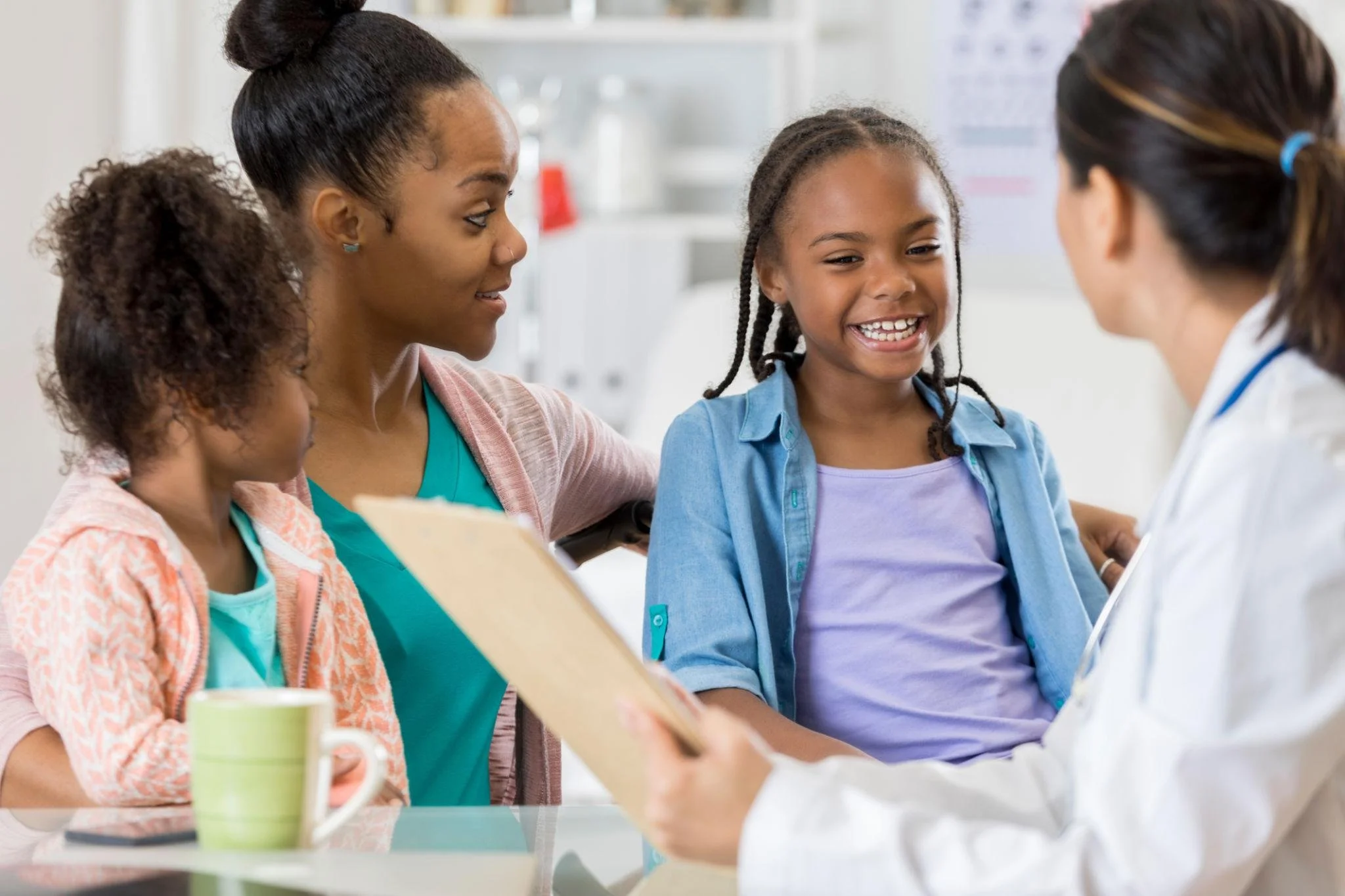 mother with her daughters at the doctor