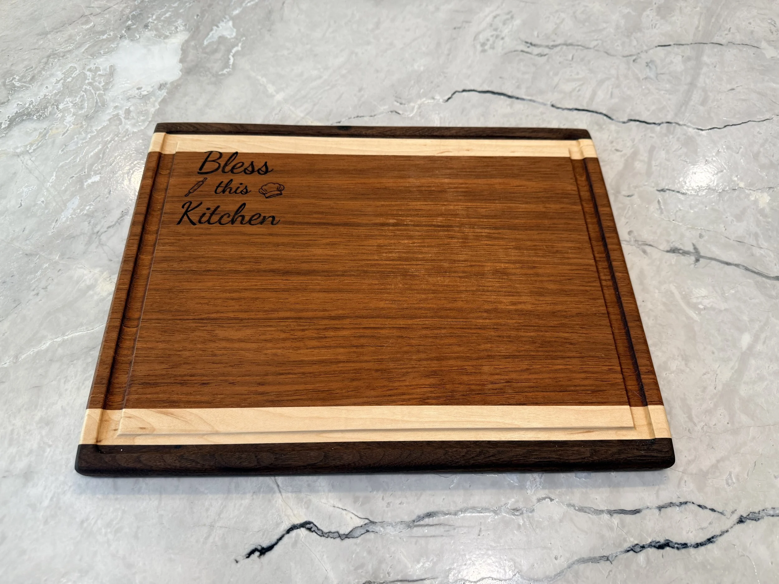 Product #: 122502

15" x 11 1/2" walnut, maple, and jatoba wood cutting board with juice groove and engraving.

$100