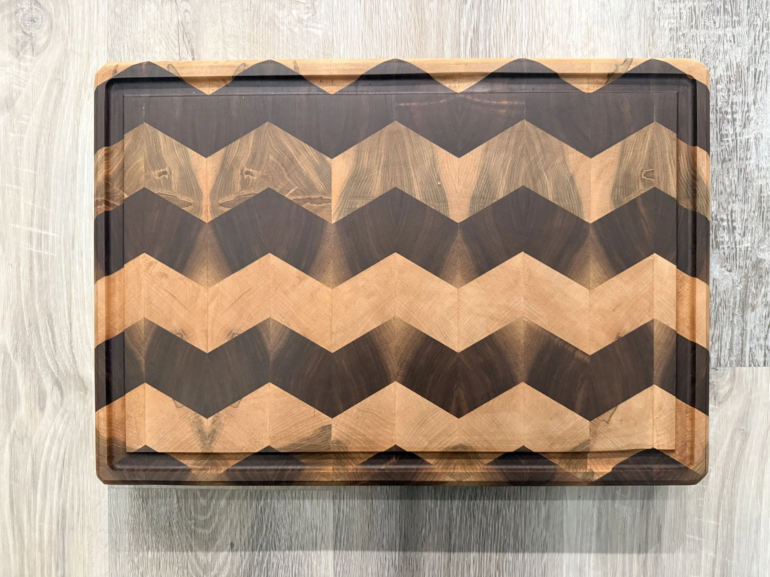 Product #: 012601

17" x 12" x 1 3/4" Black walnut and ambrosia maple chevron patterned end grain cutting board w/ juice groove and feet

$250

**Bundle w/ Product #012602 for $300**