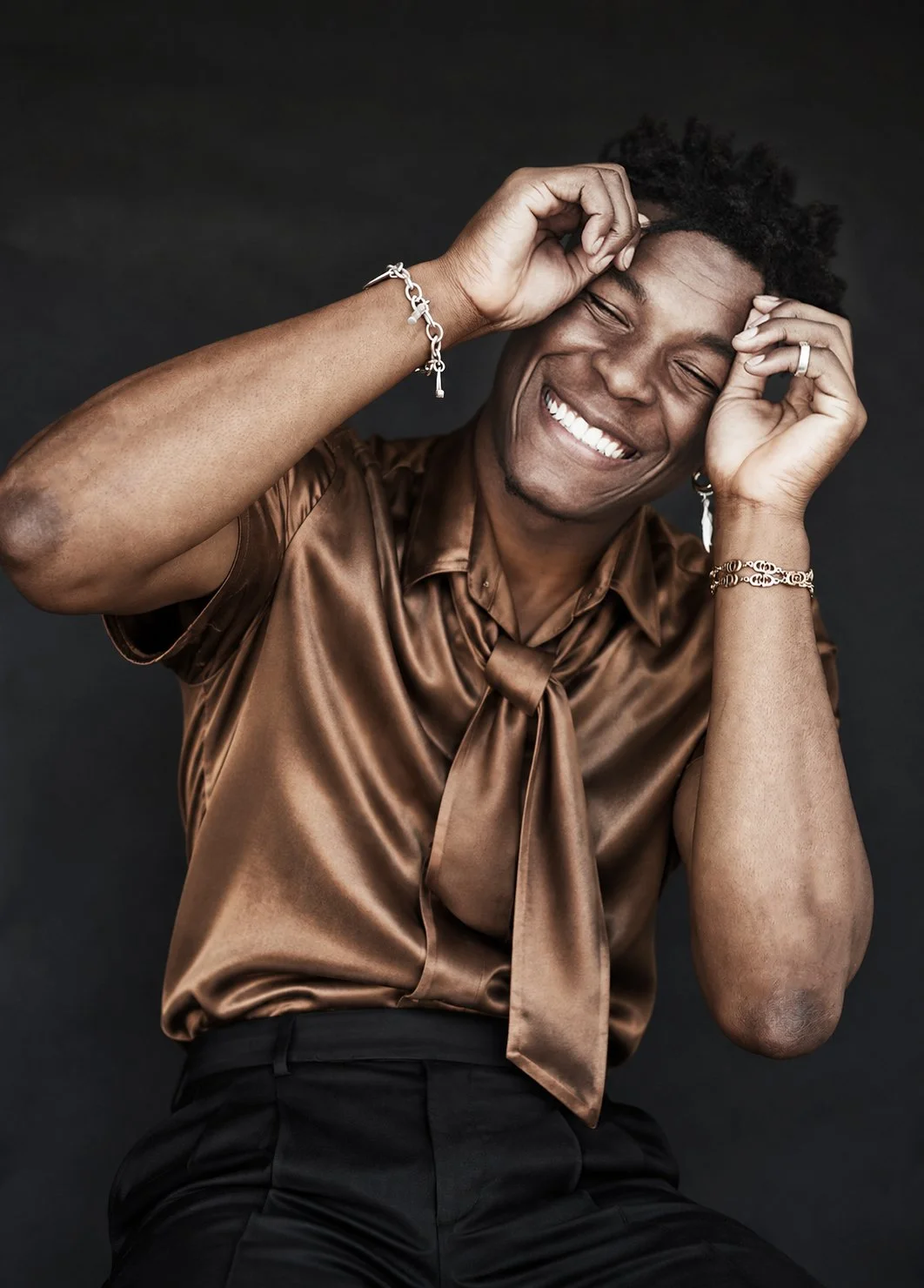 Laughing seated portrait in a bronze shirt