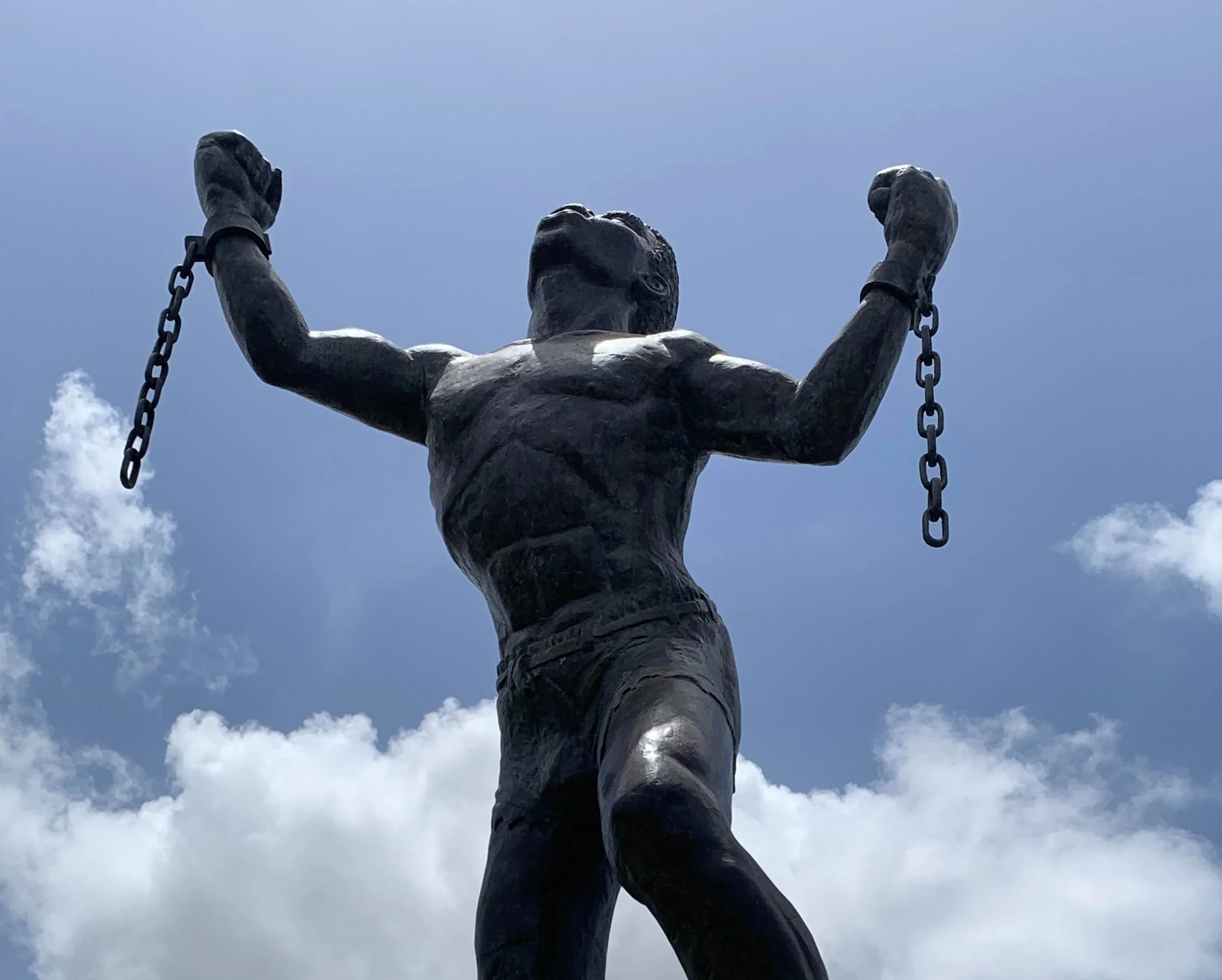 Powerful Statue of Slave from Barbados Breaking Shackles