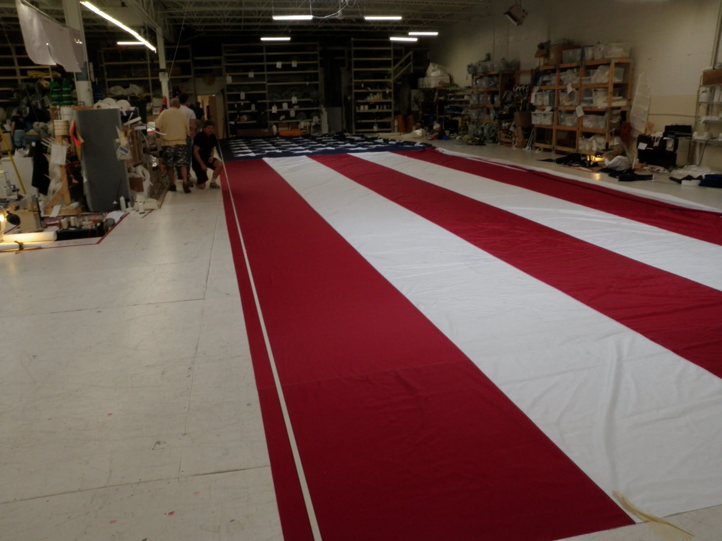 Large American flag being assembled in a workshop