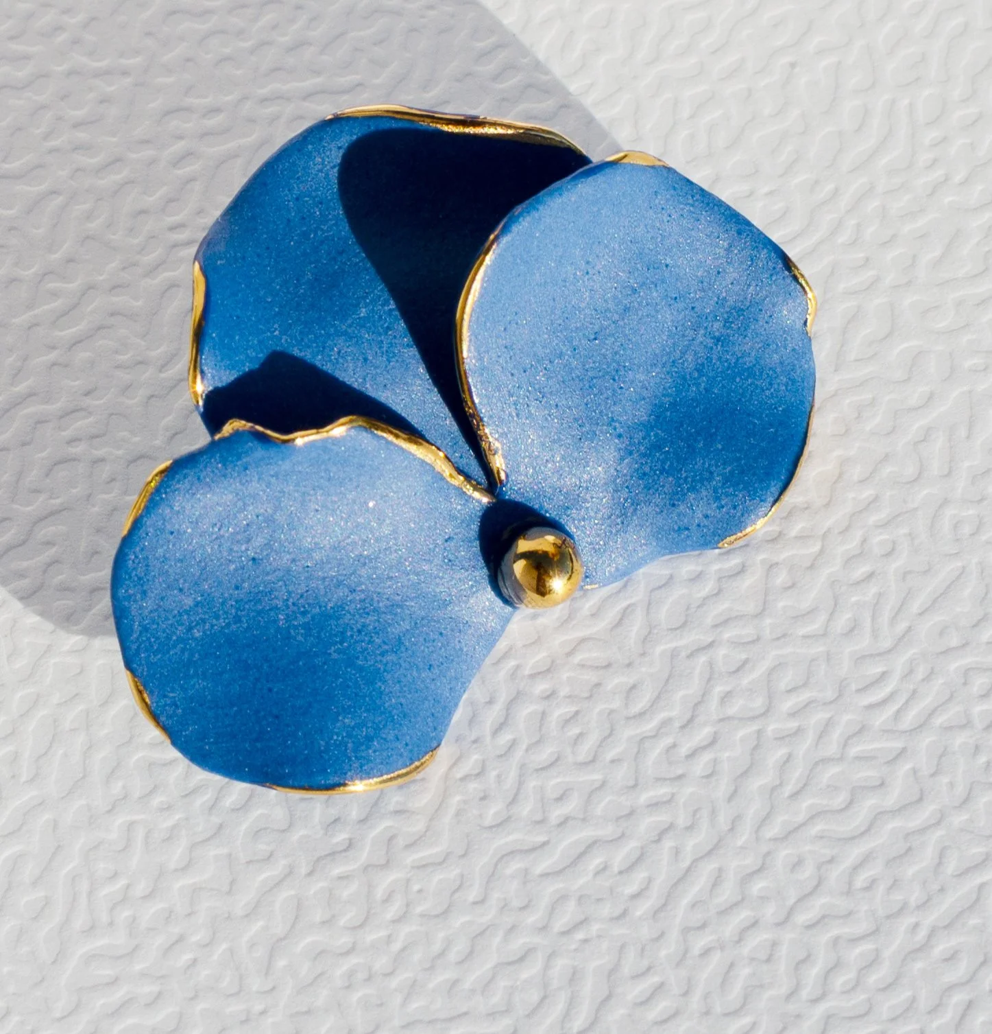 Handmade porcelain brooch with 24k gold details.