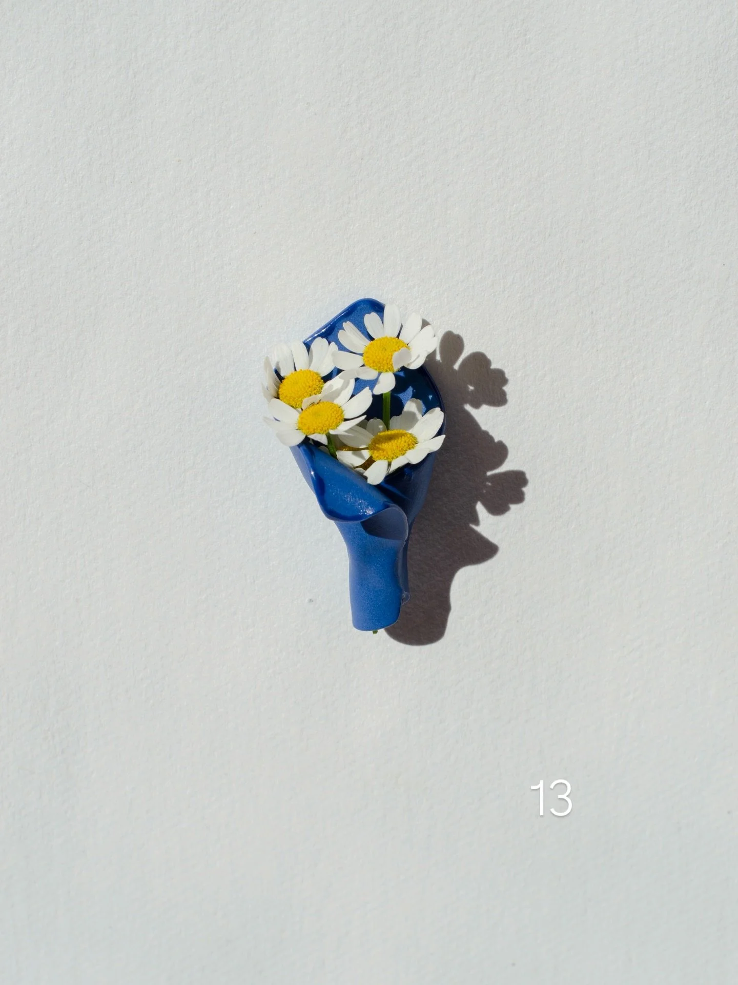 Inspired by the simple gesture of picking a bloom along the way, these porcelain brooches imitate a small bouquet wrap &mdash; one you can pin on and fill with a flower.

Here are 11 more models, each unique, priced at &euro;25.
Sizes range from 3 to