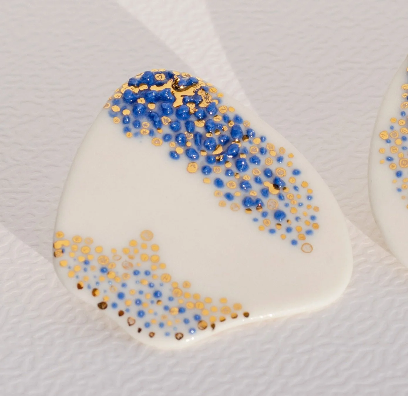 If Only for a Moment earrings 
Available on raiars.com

Entirely hand-carved in porcelain &middot; blue porcelain and 24k gold accents &middot; Sterling silver posts