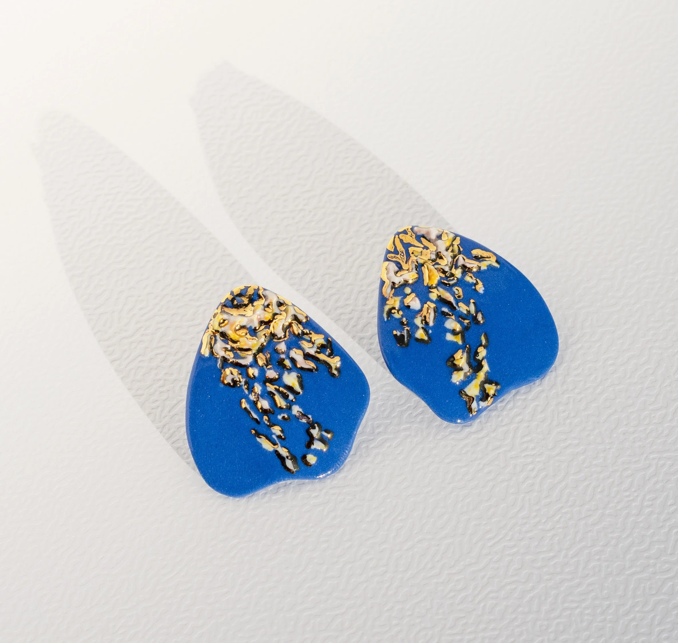 Caught some sunshine on a wave.

Waveglow earrings 
Available on raiars.com

Entirely hand-carved in blue porcelain &middot; 24k gold accents &middot; Sterling silver posts