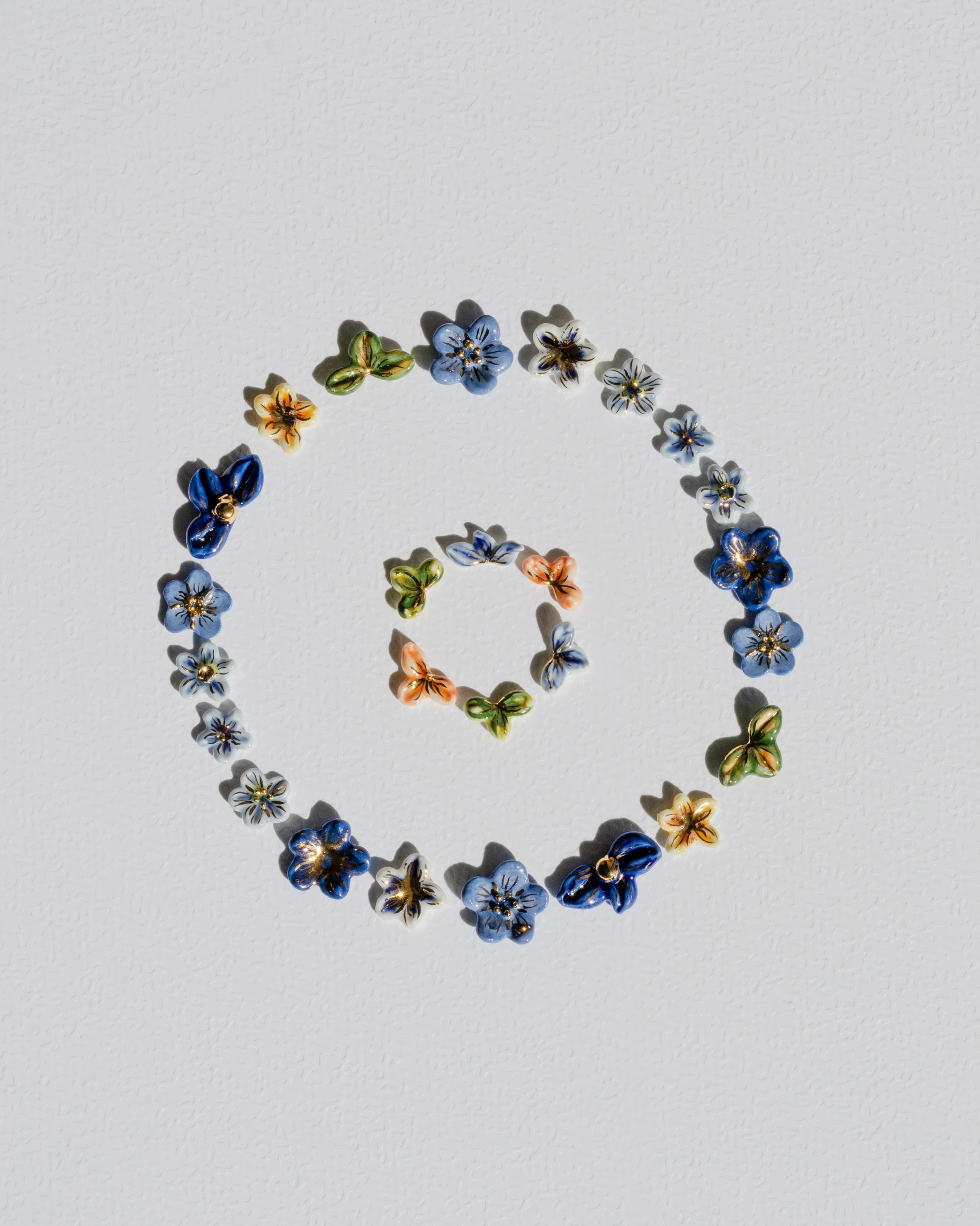 I wanted to see how small I could go with porcelain.

Turns out, the smaller, the harder. Some were even too tiny for the silver posts. 😅

I really enjoyed making these earrings. I was curious, had fields of tiny flowers and forget-me-nots in my hea