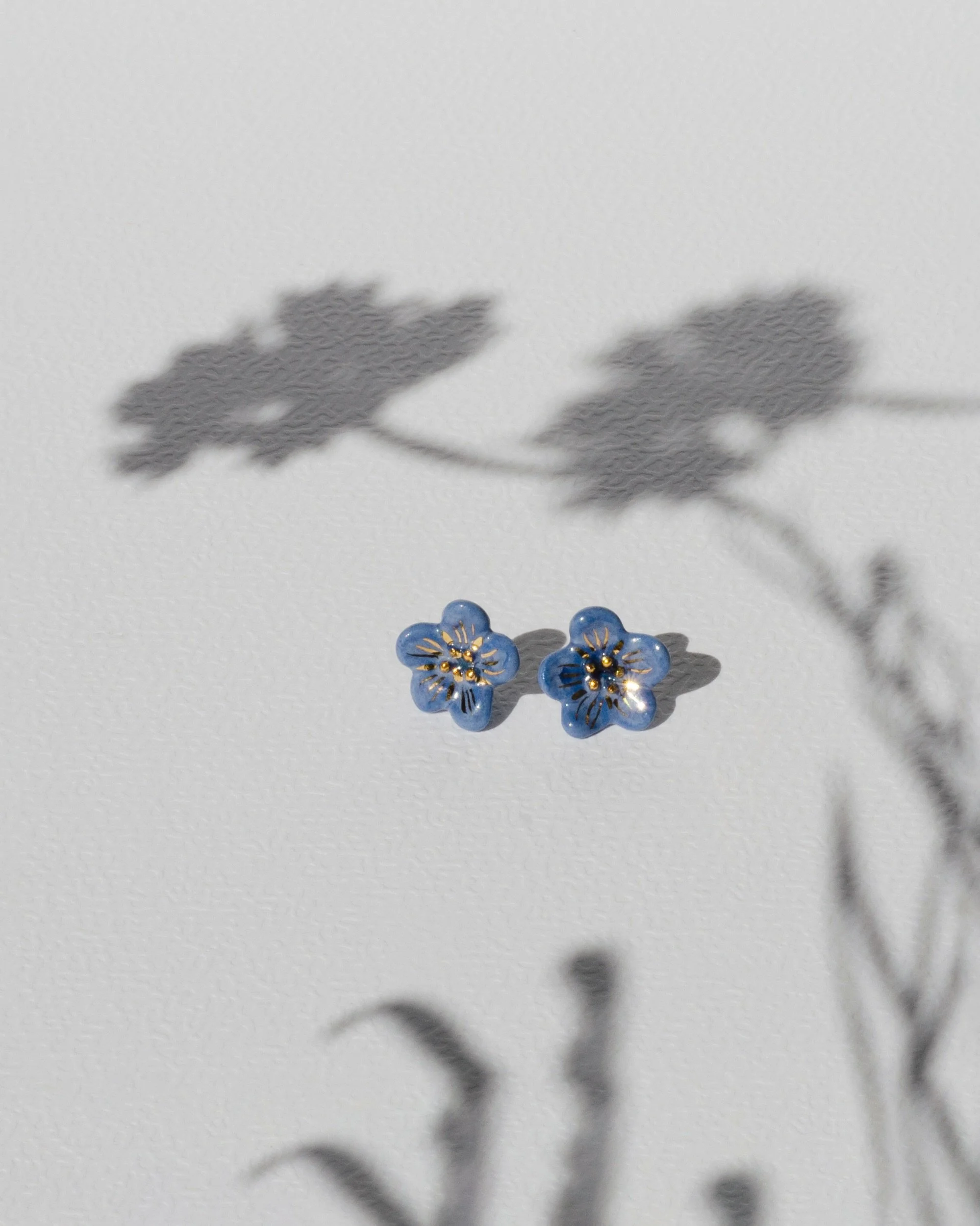 There in the Grass earrings 

You know when you&rsquo;re walking and suddenly spot a tiny flower in the grass? You don&rsquo;t even know what it is, but somehow it feels familiar.

These little blue flowers came from somewhere around there.

Availabl