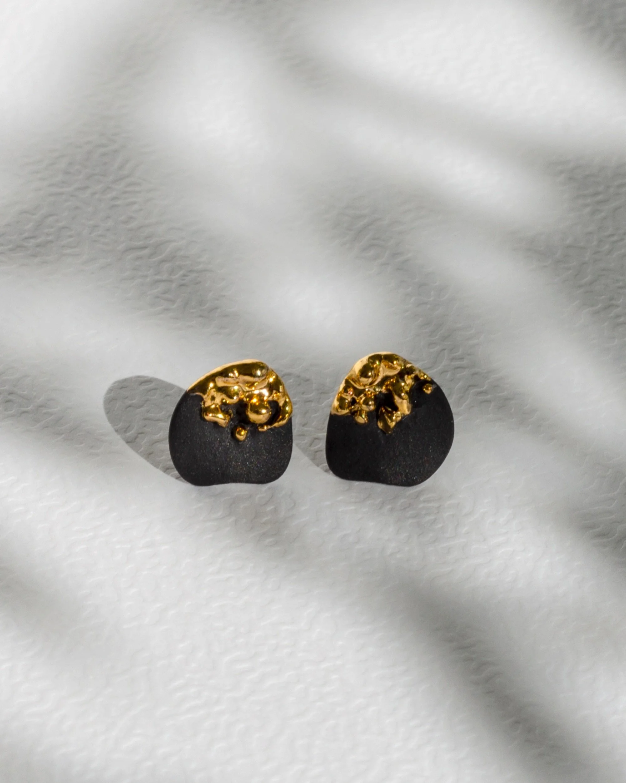 A Little Sunny Spot earrings

Available on raiars.com
Hand-carved black porcelain &middot; 24k gold &middot; sterling silver posts

Really tiny, carrying little glimmers of light.

Apparently this is how I do product photos. 😅
Earrings on, inspirati