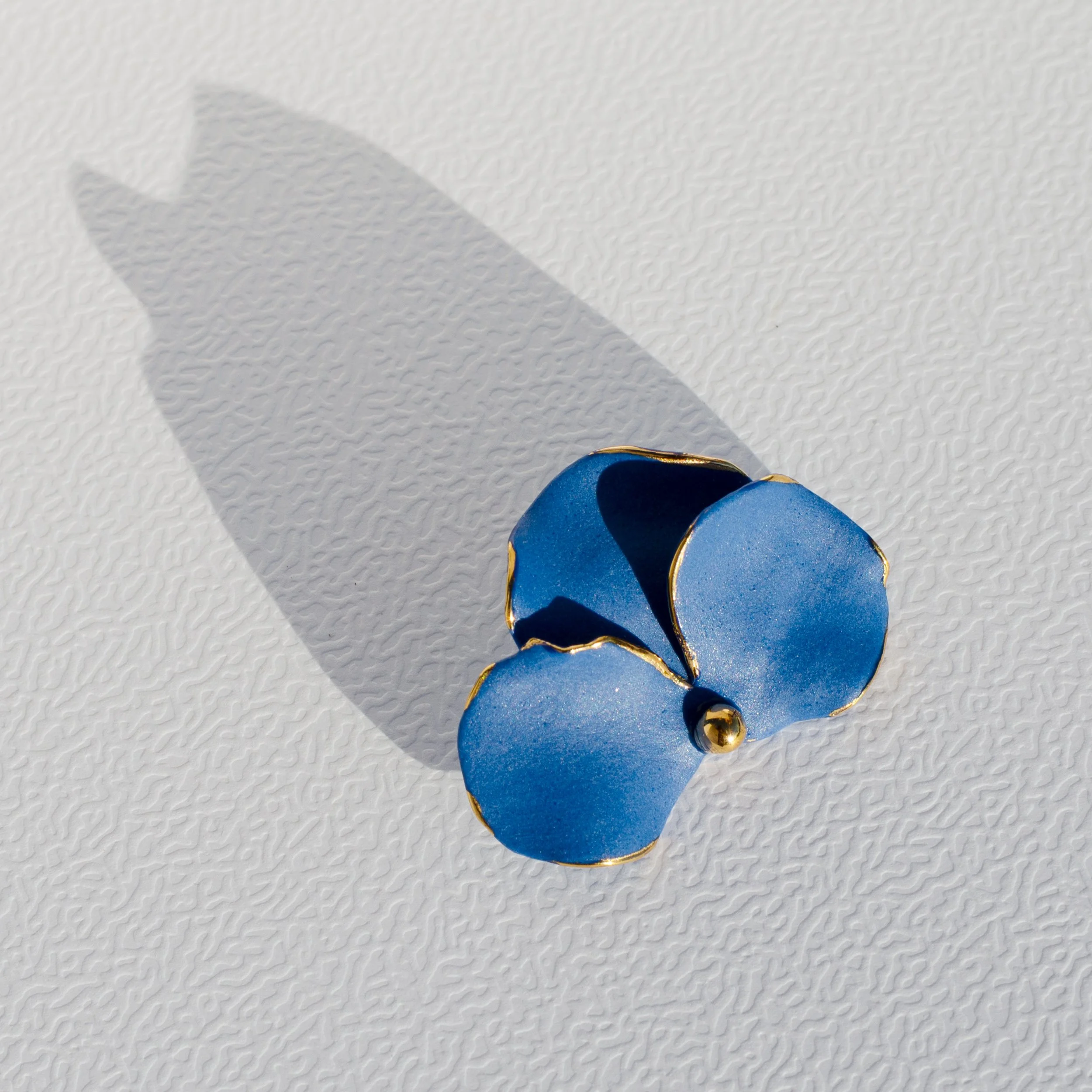 Handmade porcelain brooch with 24k gold details.
