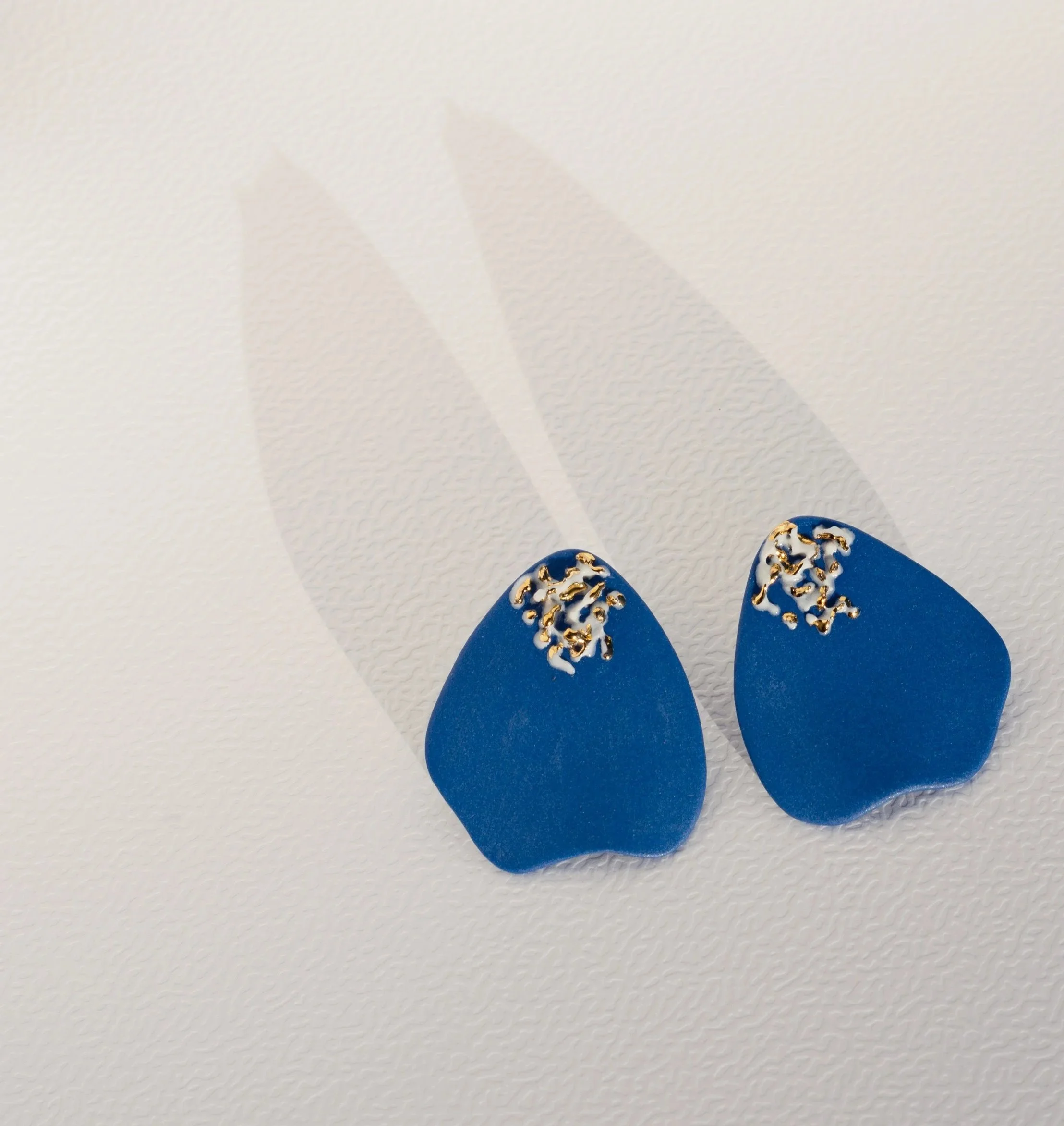 Handmade porcelain earrings with 24k gold details, fitted with 925 sterling silver posts and butterfly backs.