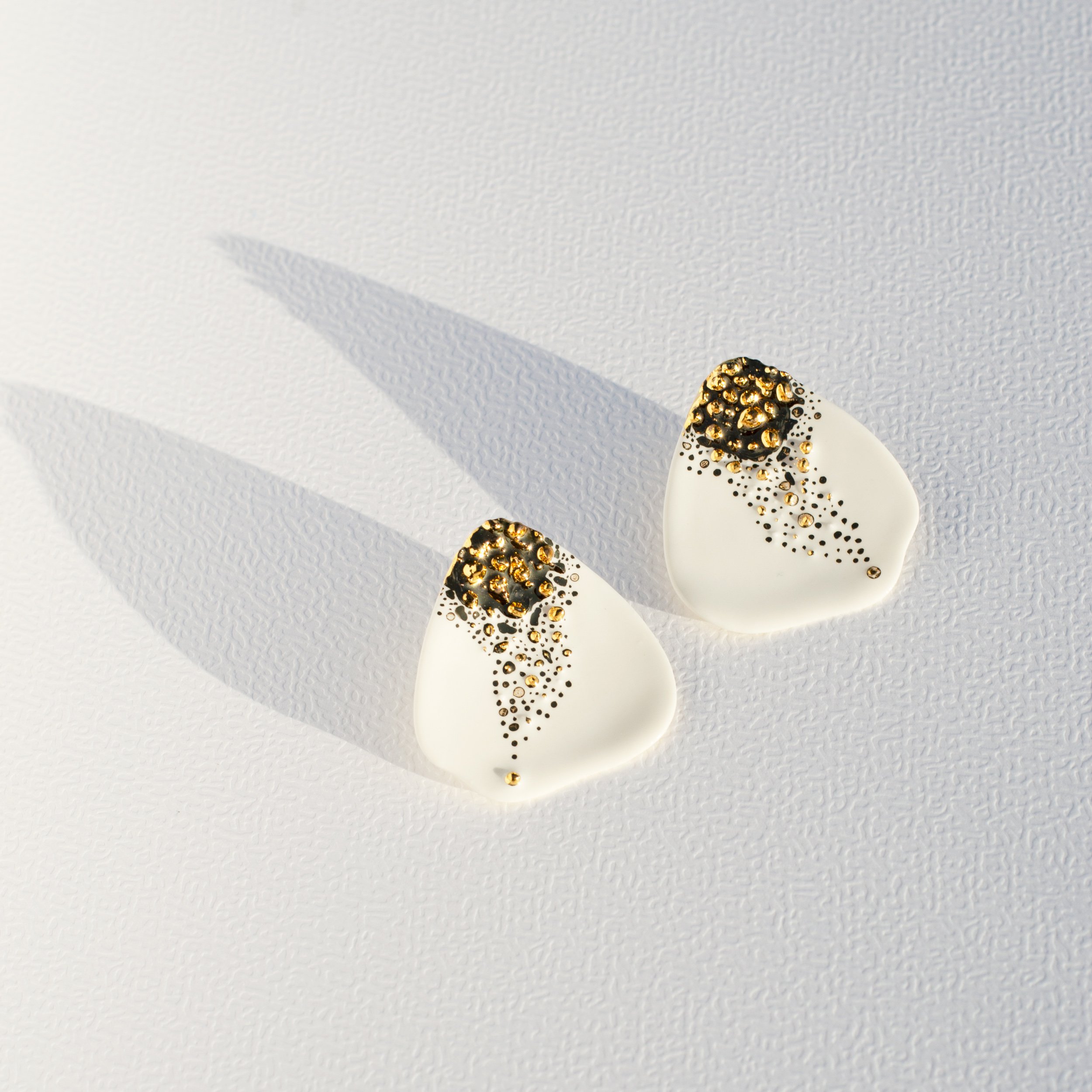 Handmade porcelain earrings with 24k gold details, fitted with 925 sterling silver posts and butterfly backs.