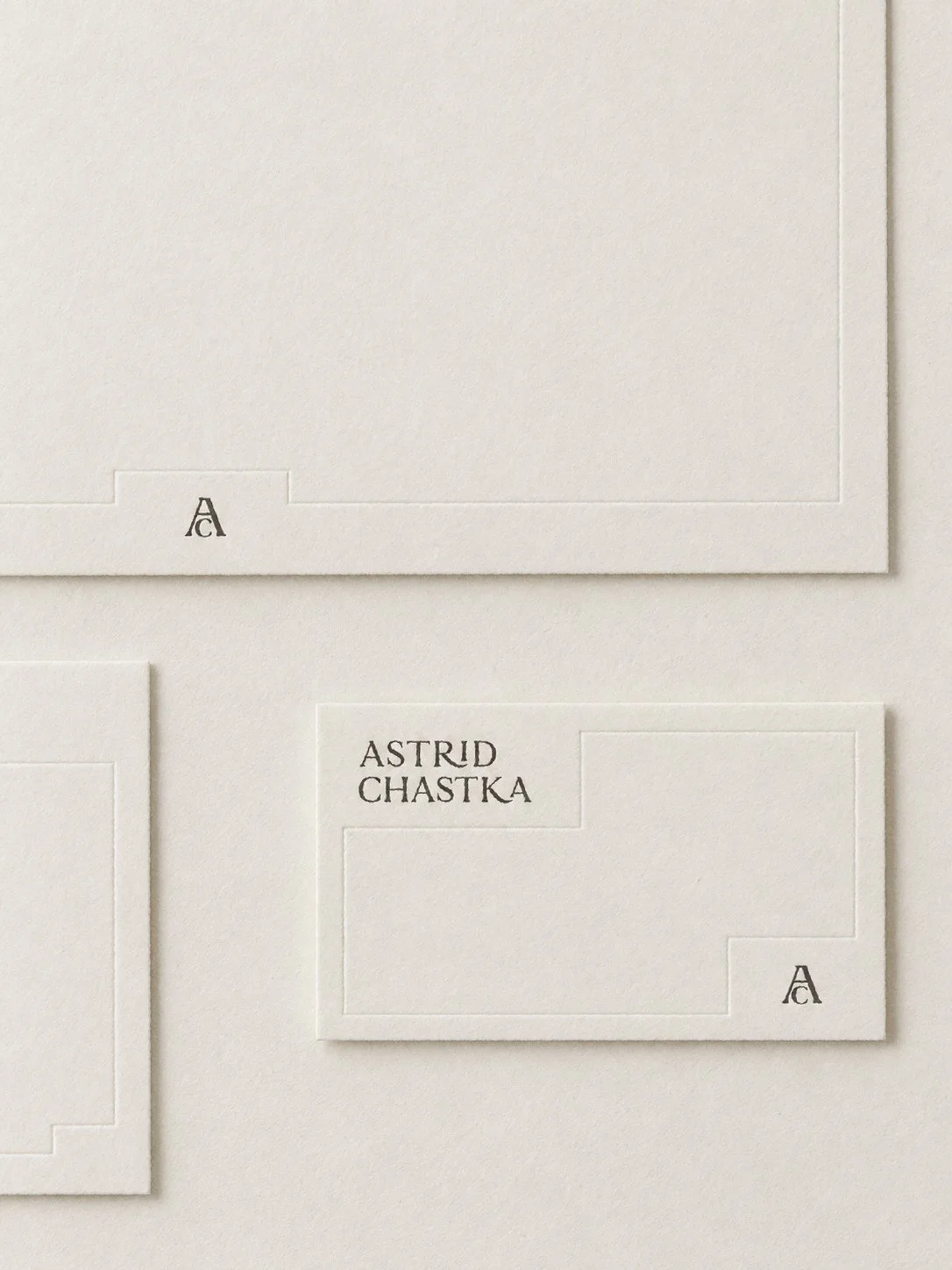 White stationery with black text displaying the name 'Astrid Chastka' and a small letter 'A' in the corners.