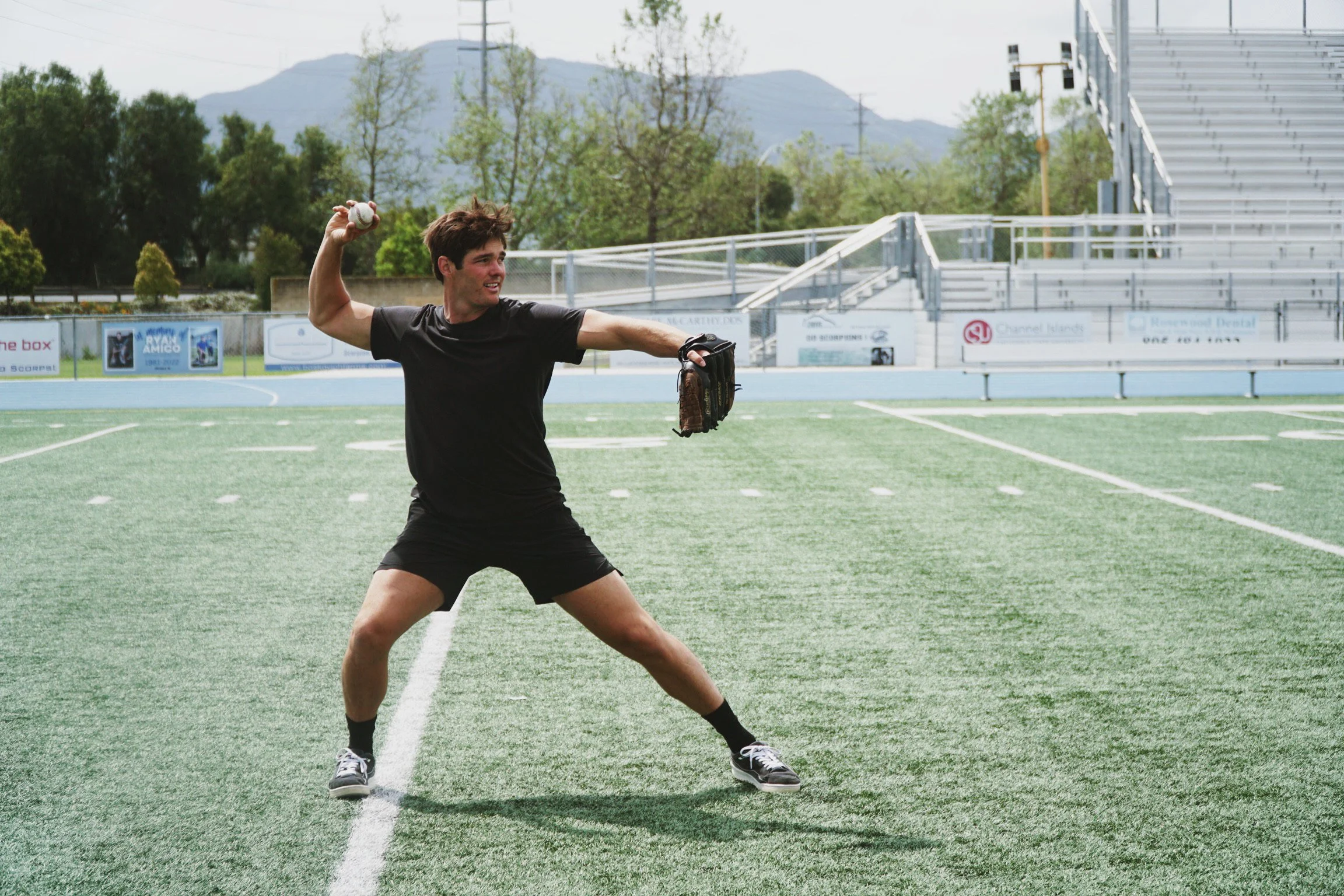 Man throwing a baseball on a sports field