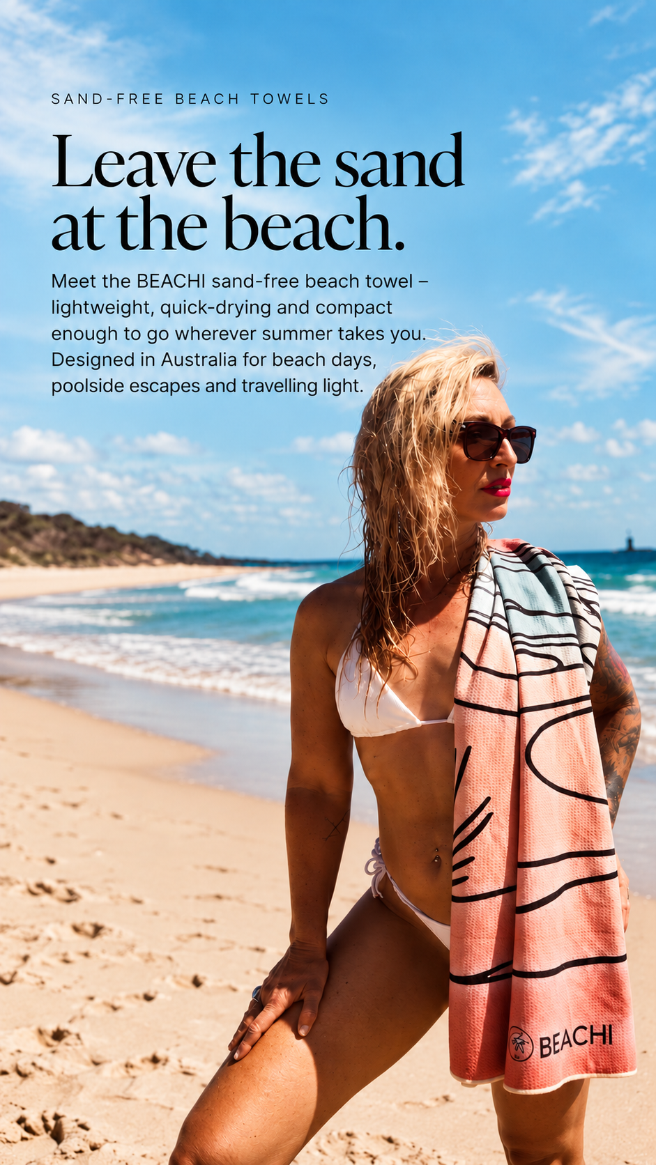 Advertisement for BEACHI sand-free beach towels featuring a woman in a white bikini on the beach, holding a pink towel with black stripes, with the ocean and a partly cloudy sky in the background.