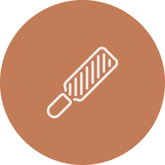 Illustration of a spatula with a handle and slotted flat blade on a brown circular background.