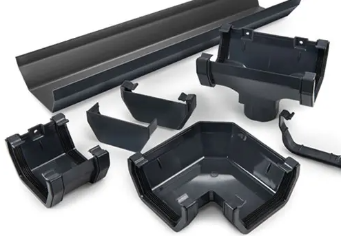 Set of black plastic edge trim and corner pieces for a gutter