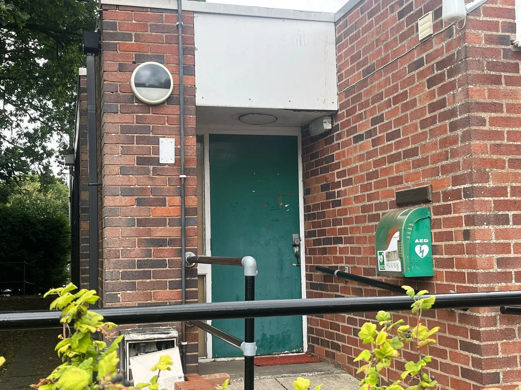 Post office entrance door, located to the left of the main gate. Includes disabled ramp for ease of access.