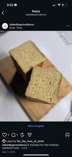 Two slices of Pullman sandwich bread on a wooden surface.