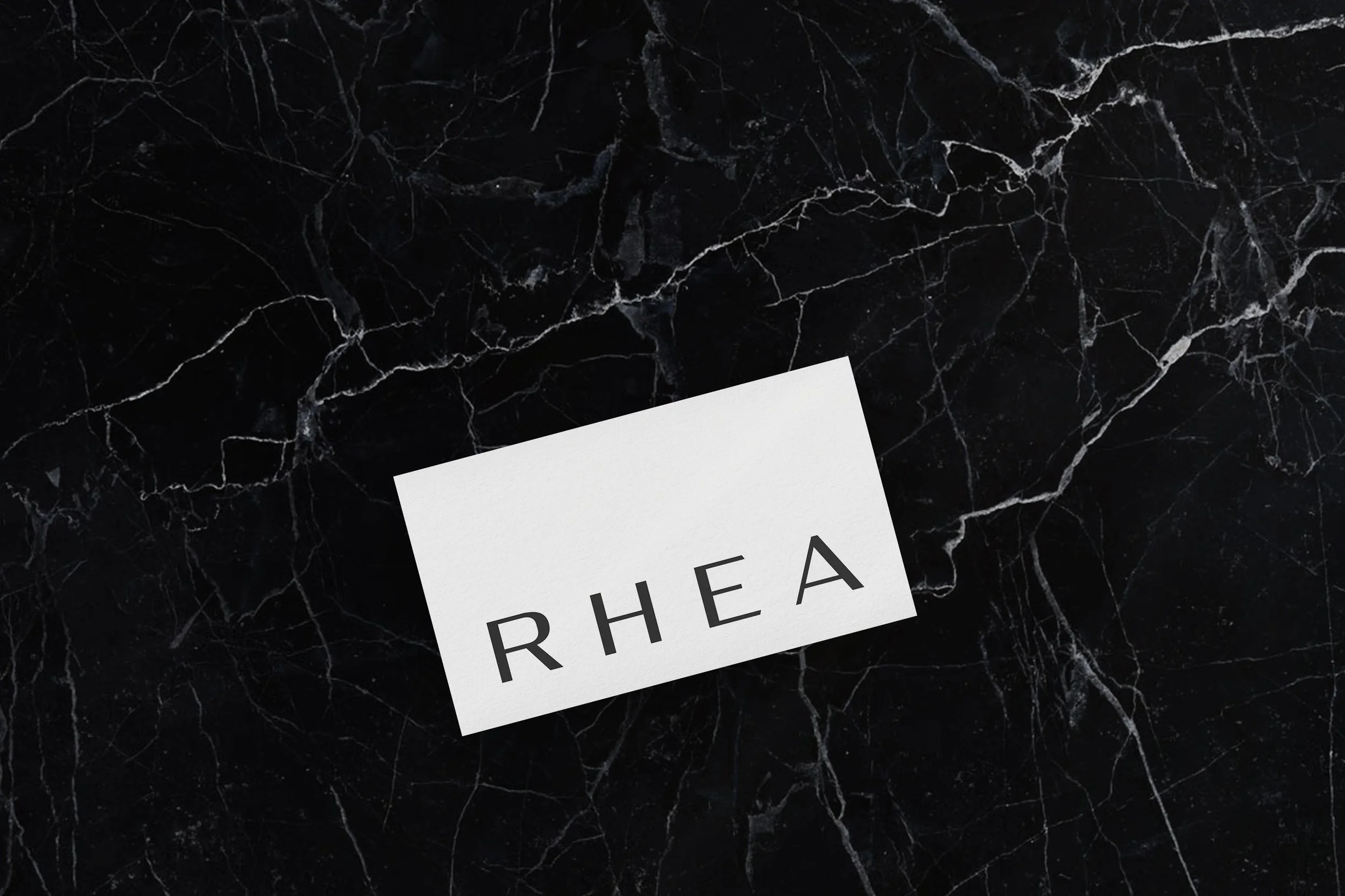 Clinic card design. The custom wordmark becomes a tactile brand asset — simple, elegant, and memorable.