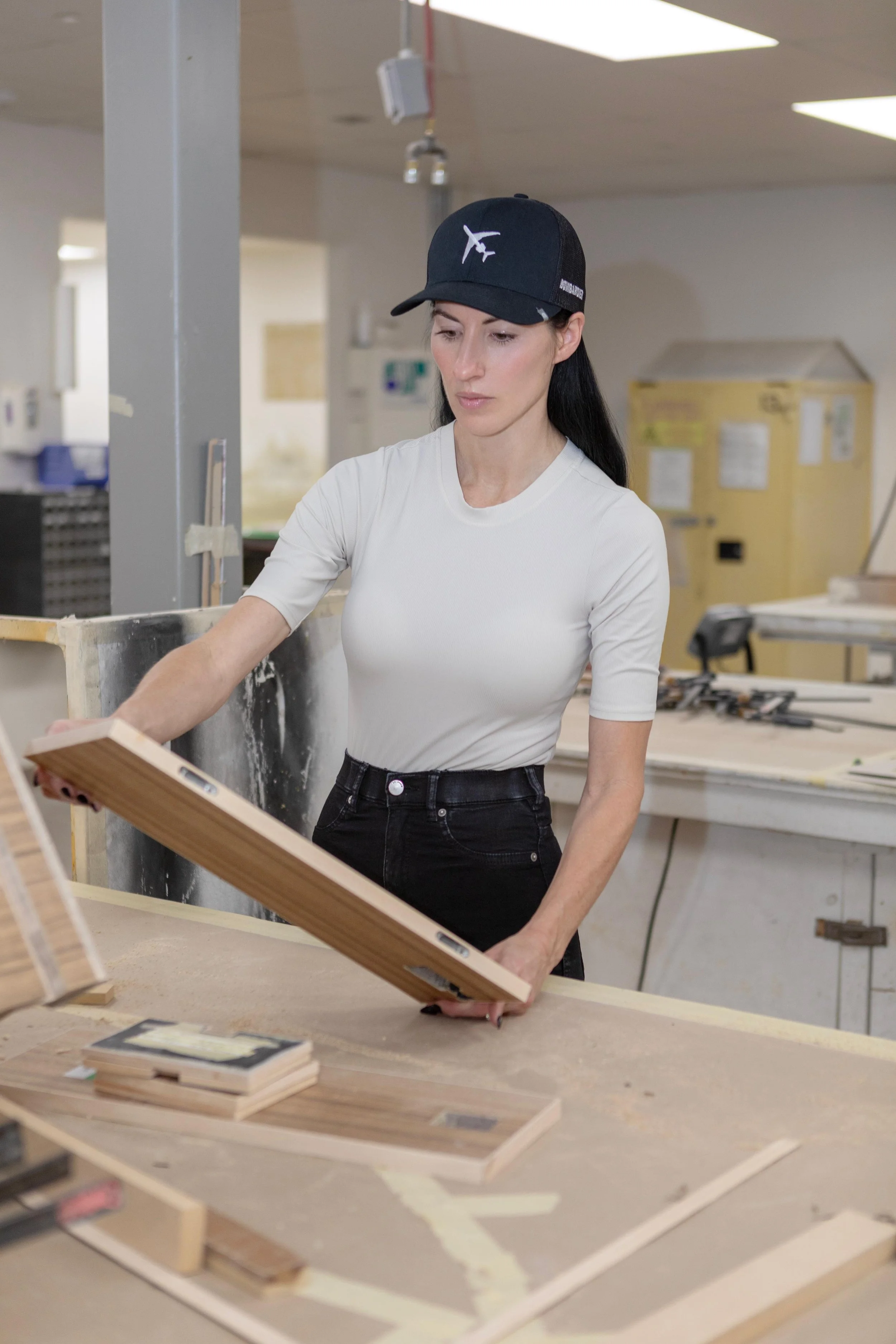 Top private jet designer, Sarah Larranaga working on an interior wood panel of a Bombardier Global 7000 private jet.