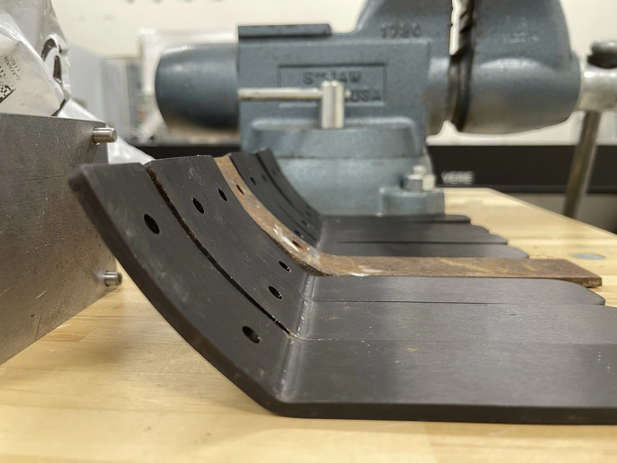  A friend of mine made a steel die for bending new anodized aluminum brackets to match the original wooden frame brackets.