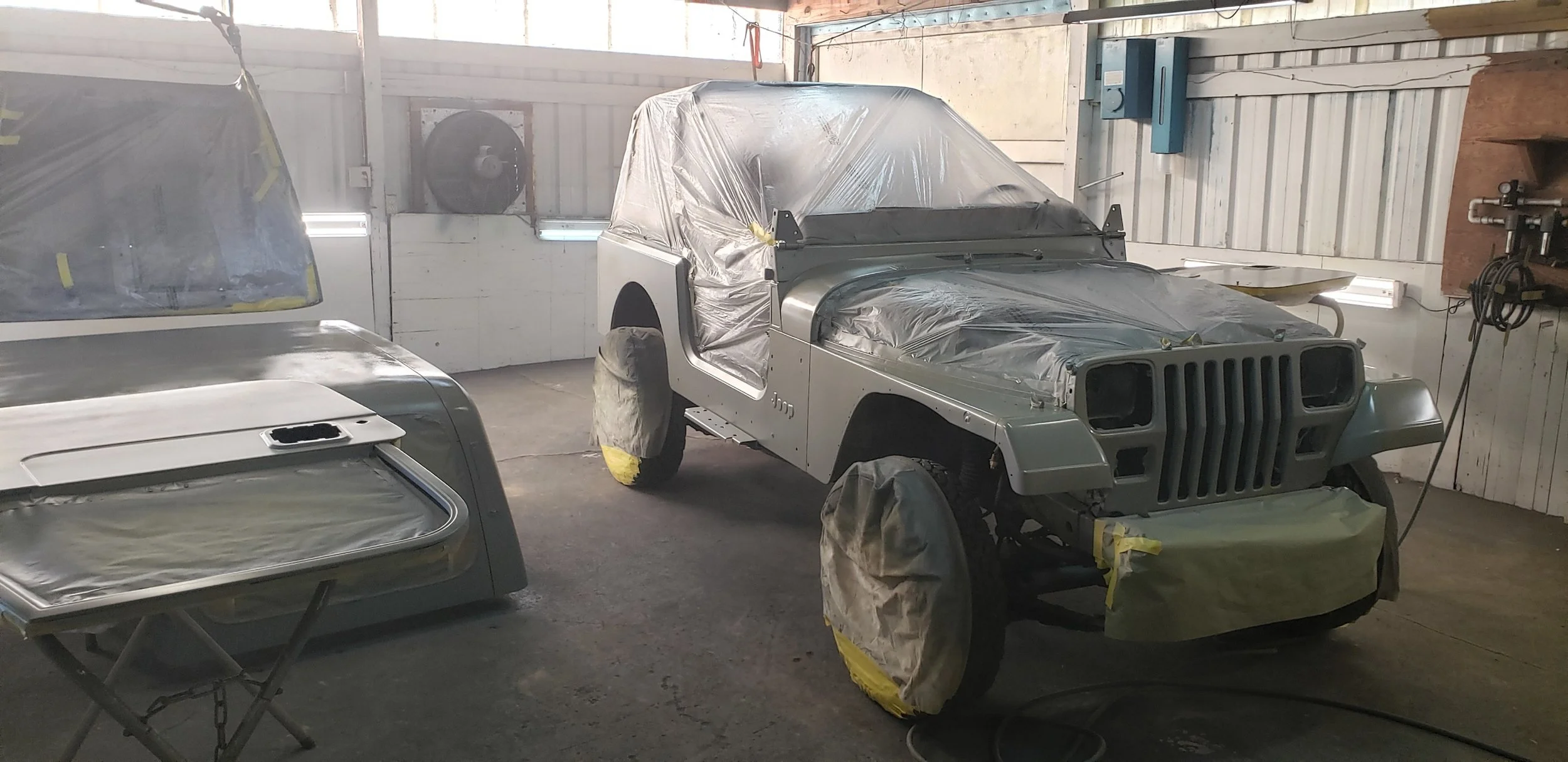 Jake's Custom Creations in Dayton, OR did the bodywork and paint. HIGHLY recommended for your Jurassic Jeep needs! He spent a week fixing some minor dents and spraying the base single-stage beige paint. 